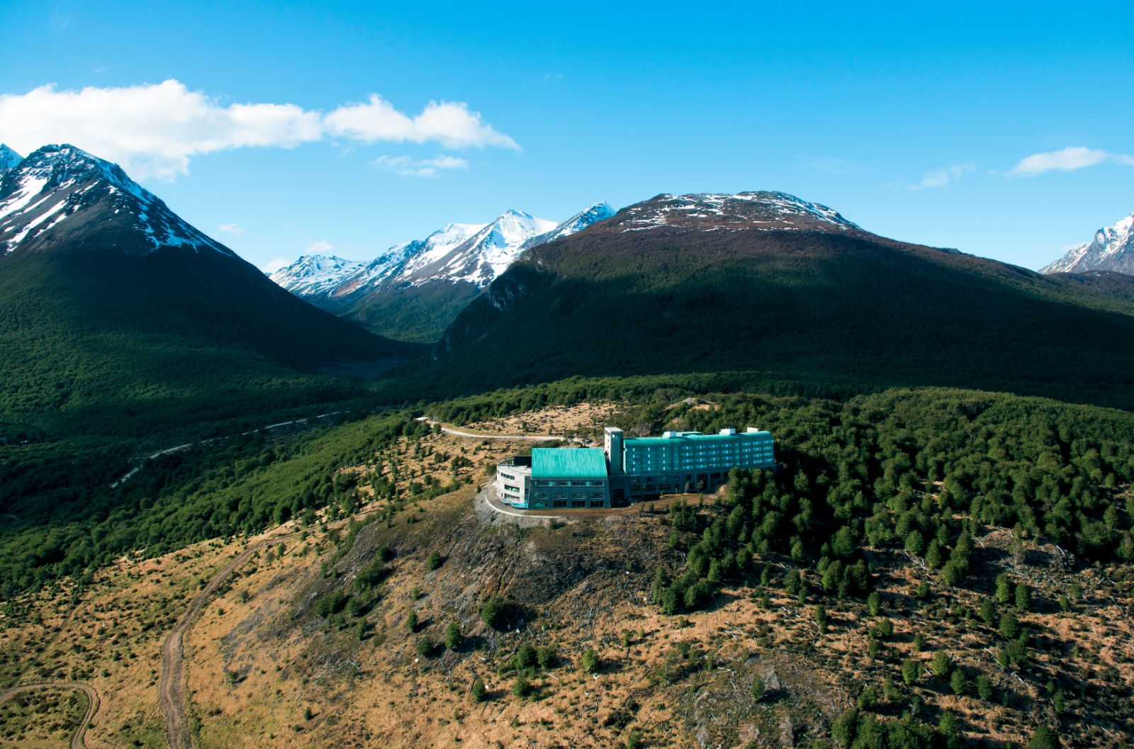Aerial view of Arakur Hotel in Ushuaia with snow-capped mountain background, Patagonia, Argentina