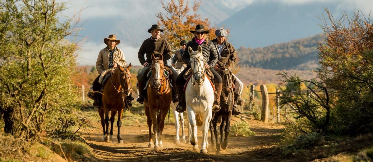 Group of people riding with the mountains in the background