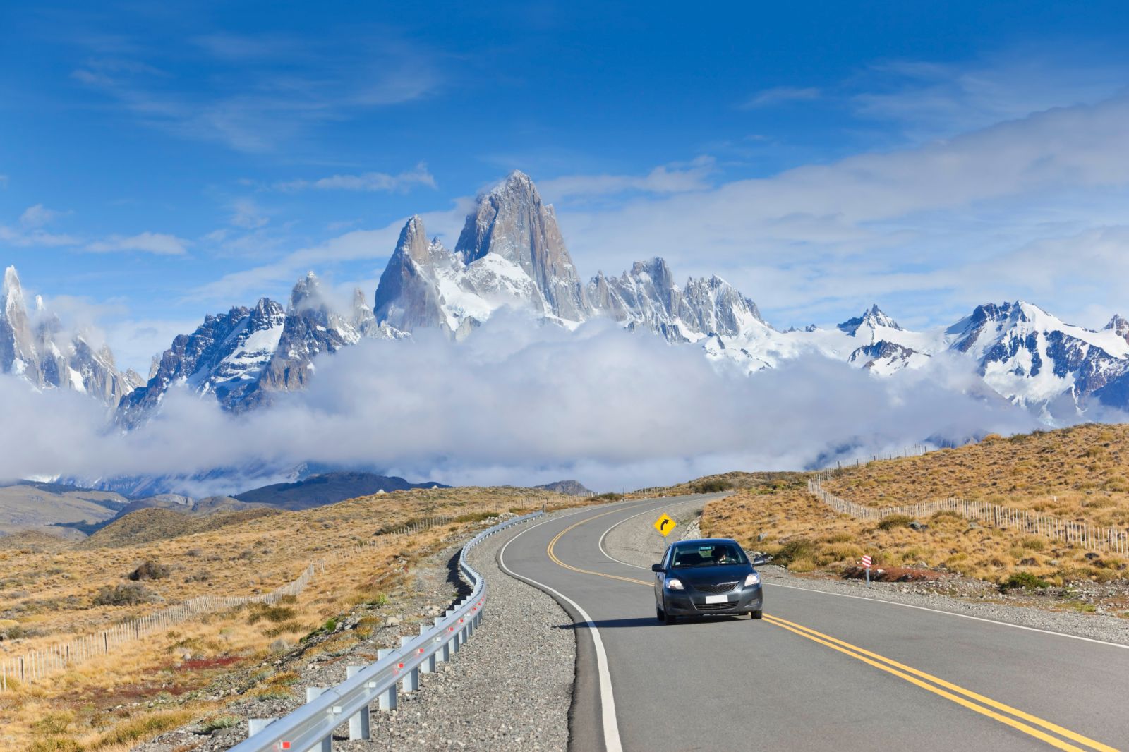 Car driving in El Chalten Argentina with the peaks of Fitz Roy in the background