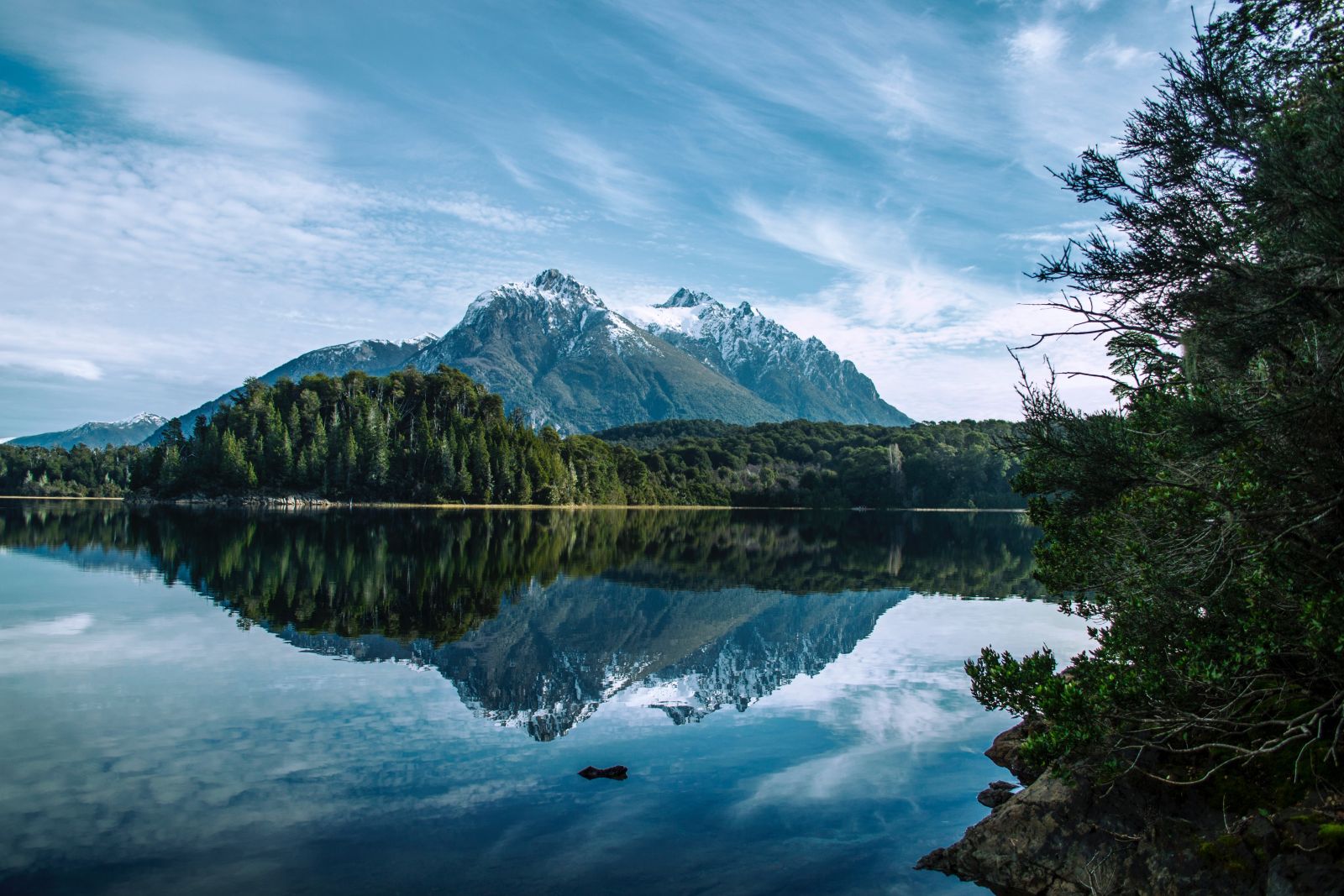 Snow peaked mountain reflected in glassy lake