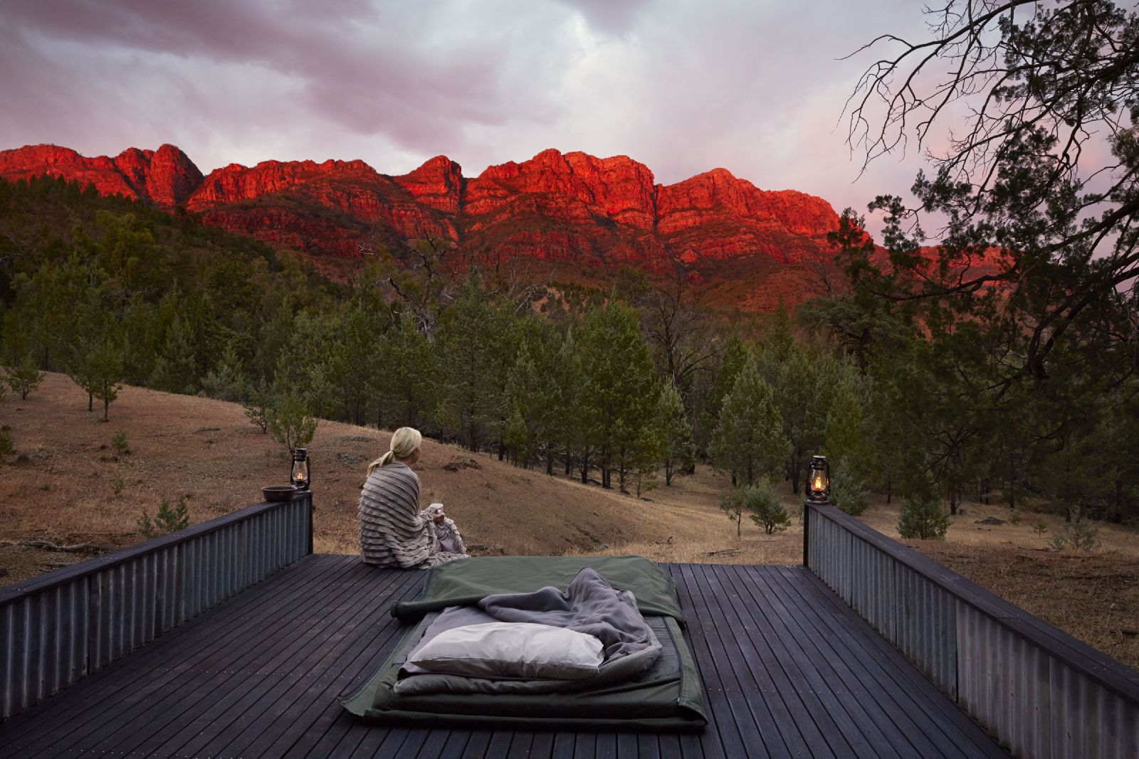 Guest at Arkaba Homestead in Australia enjoying sunrise from a day bed