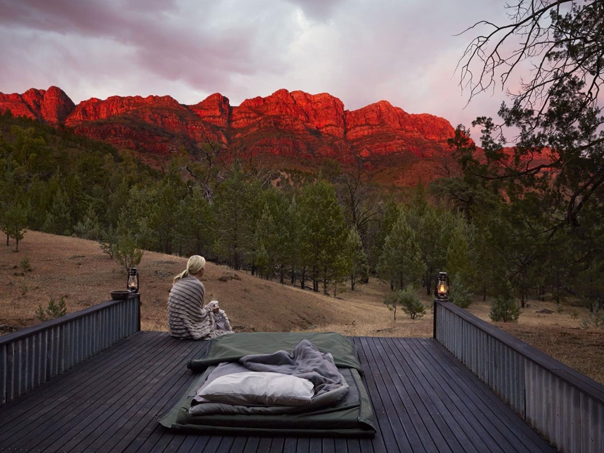 Guest at Arkaba Homestead in Australia enjoying sunrise from a day bed