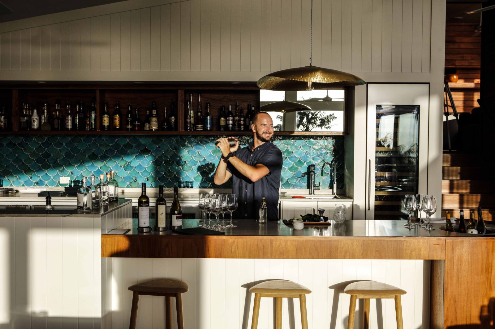sunny indoor bar with bartender making a cocktail in luxury Capella Lodge in Australia