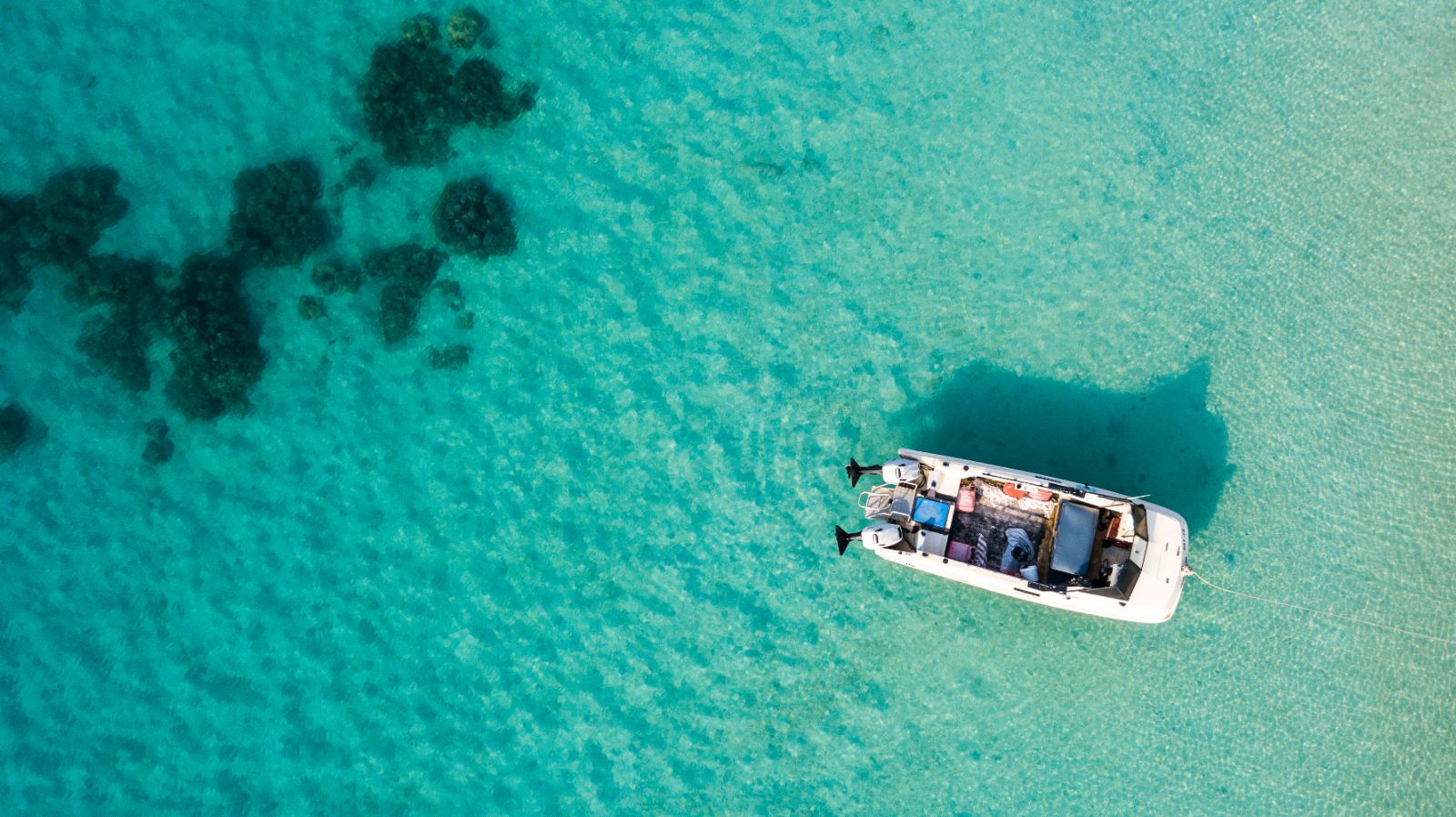 Aerial view of boat in crystal clear waters at Lizard Island, Australia 