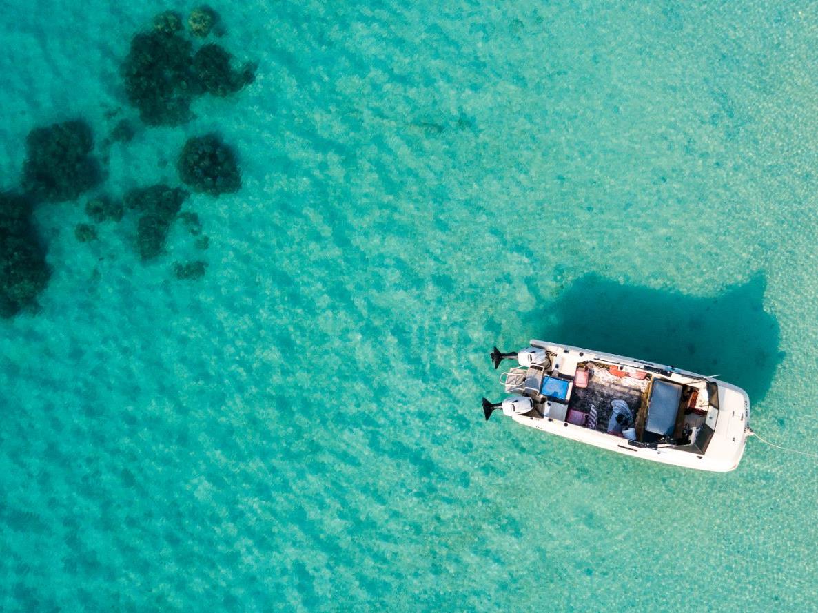 Aerial view of boat in crystal clear waters at Lizard Island, Australia