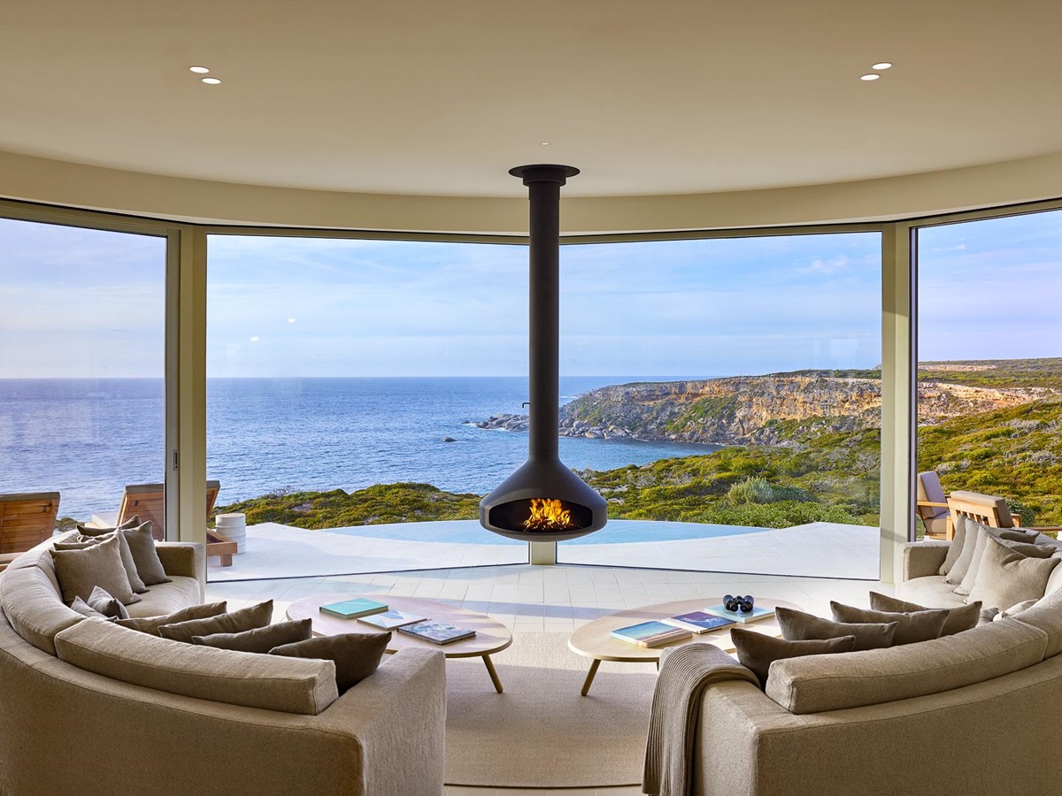 West lounge with fireplace and sea views at Southern Ocean Lodge