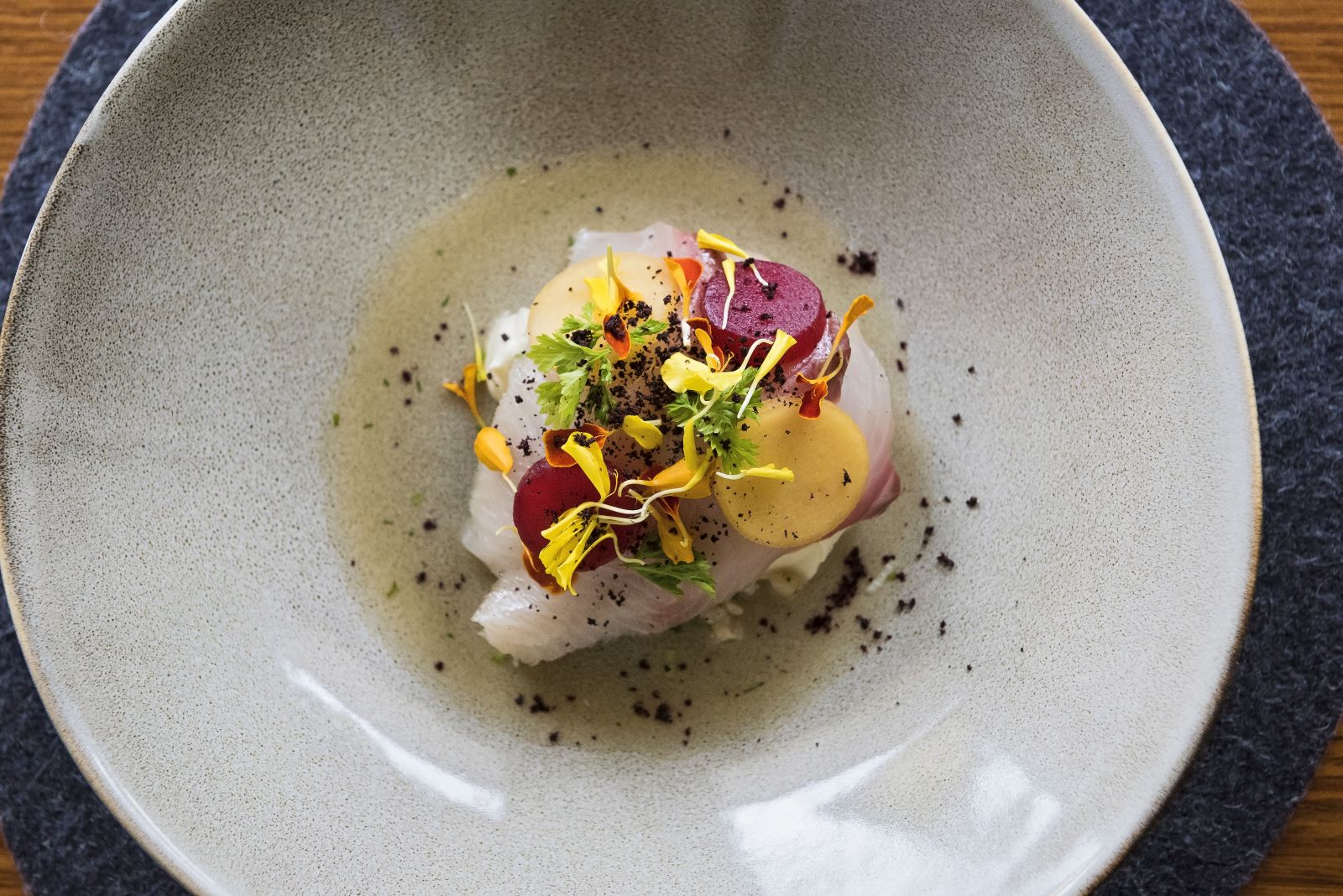Fish and colourful salad dish artfully presented