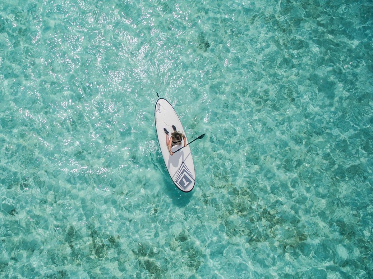 Paddle boarding in crystal clear waters in Australia