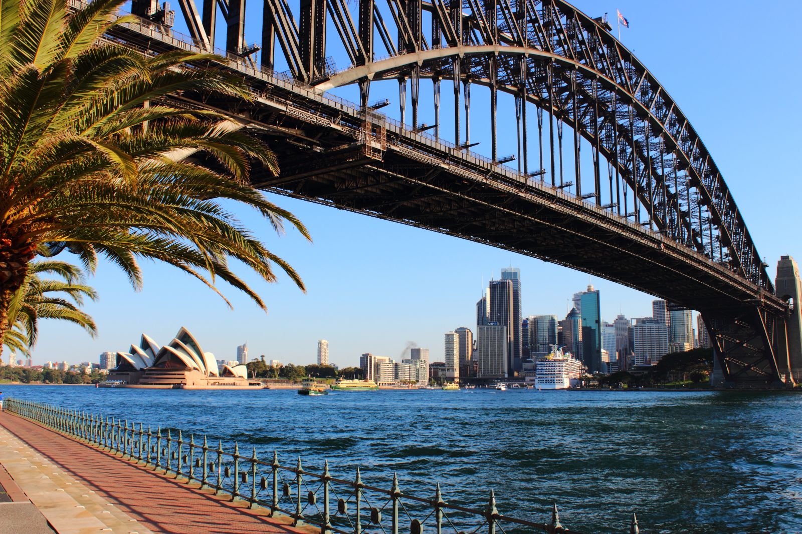 Looking up at Sydney Harbour bridge with the Sydney Opera House in the background