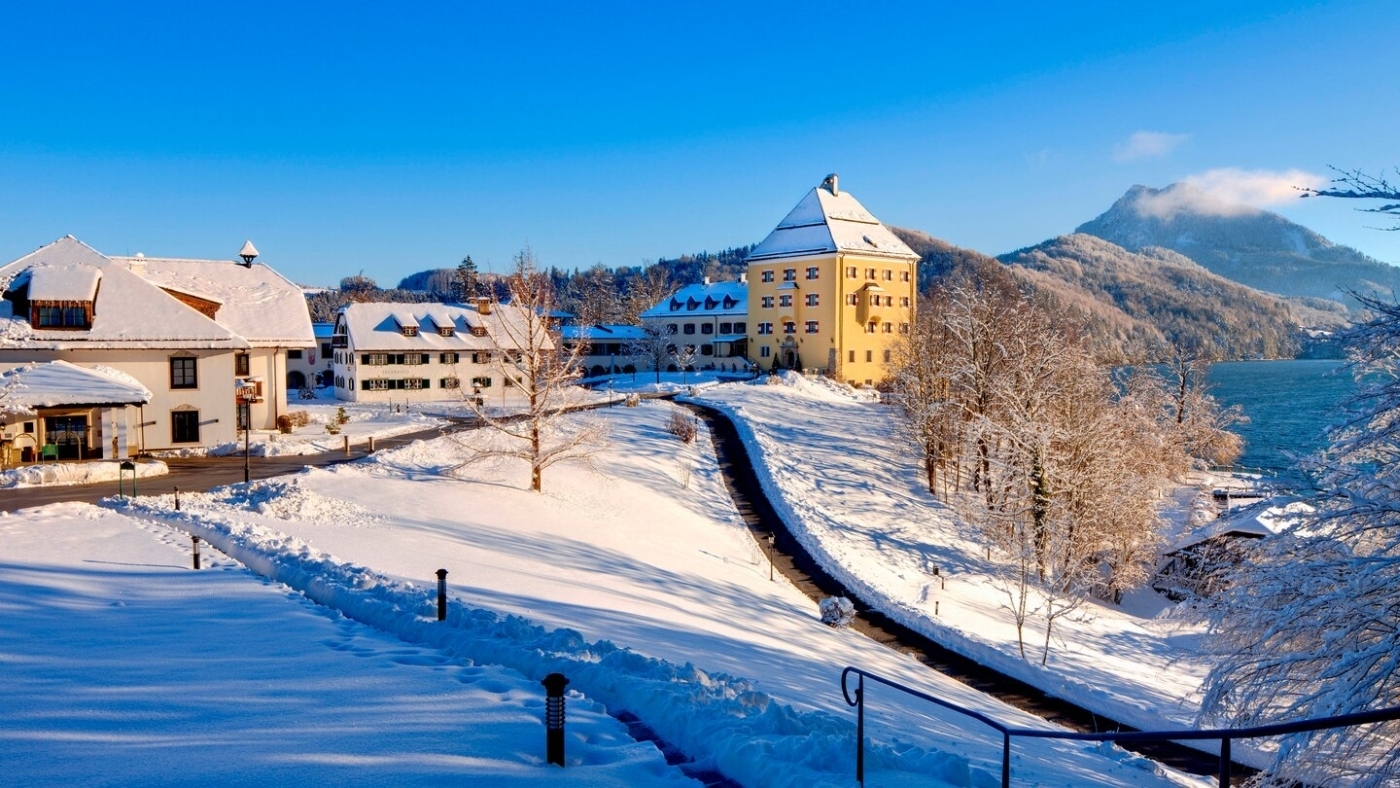 Exterior of hotel in the snow at Schloss Fuschl in Austria
