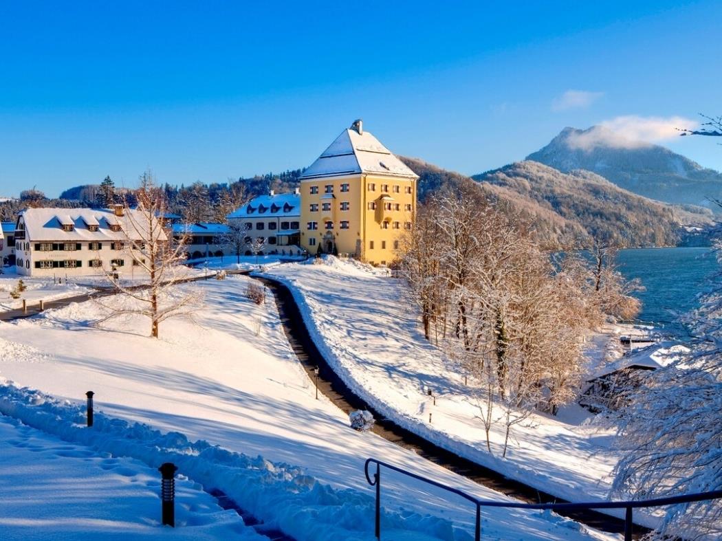 Exterior of hotel in the snow at Schloss Fuschl in Austria