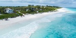 Aerial view of villa and beach with white sand and crystal blue water at Sea Siren in the Bahamas, Caribbean