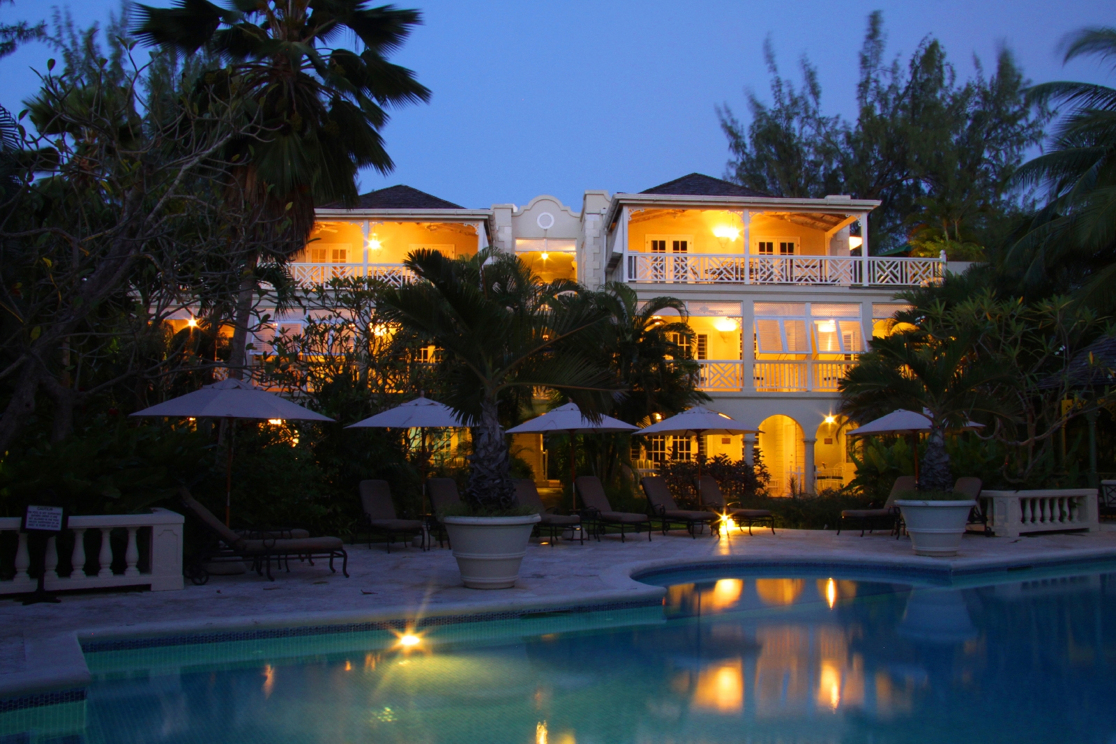 facade and swimming pool by night at coral reef club, barbados