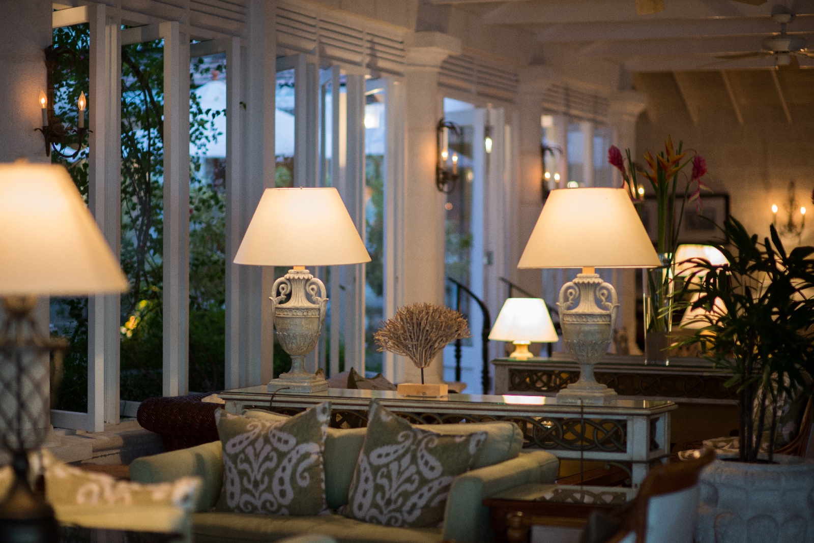 a lounge lit by lamps at coral reef club, barbados
