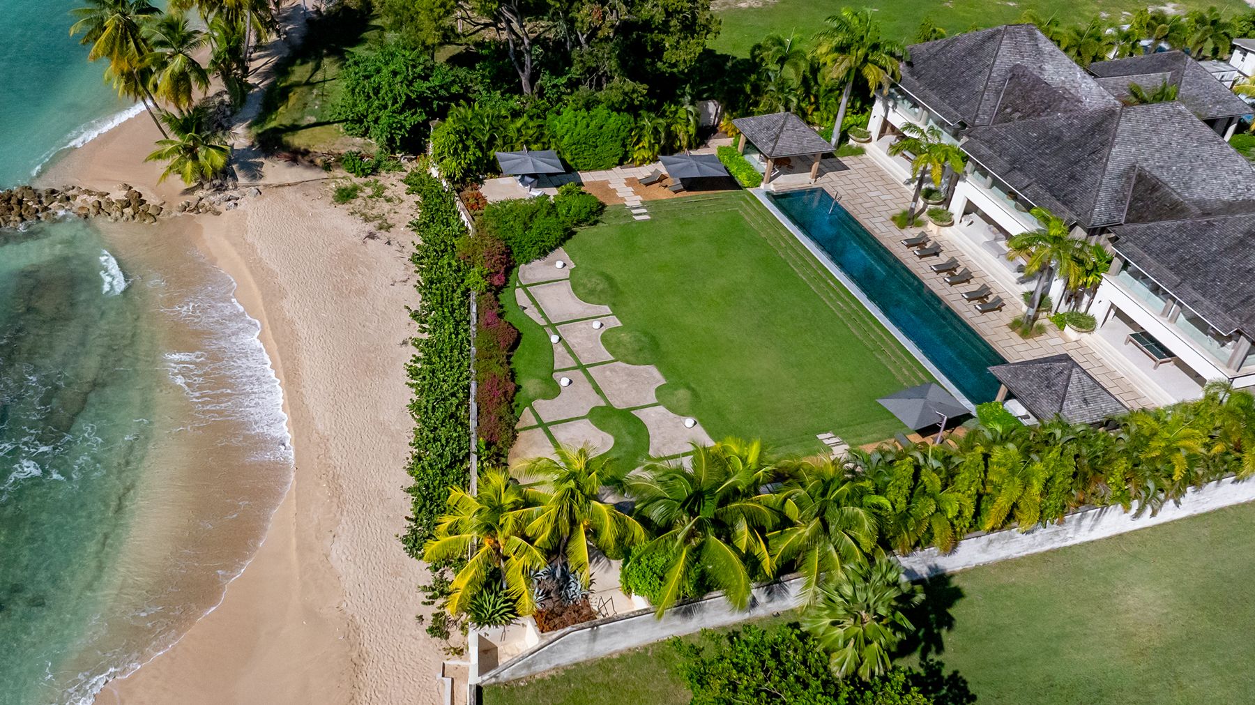 Aerial shot of villa with its garden and the beach at Godings Beach House in Barbados