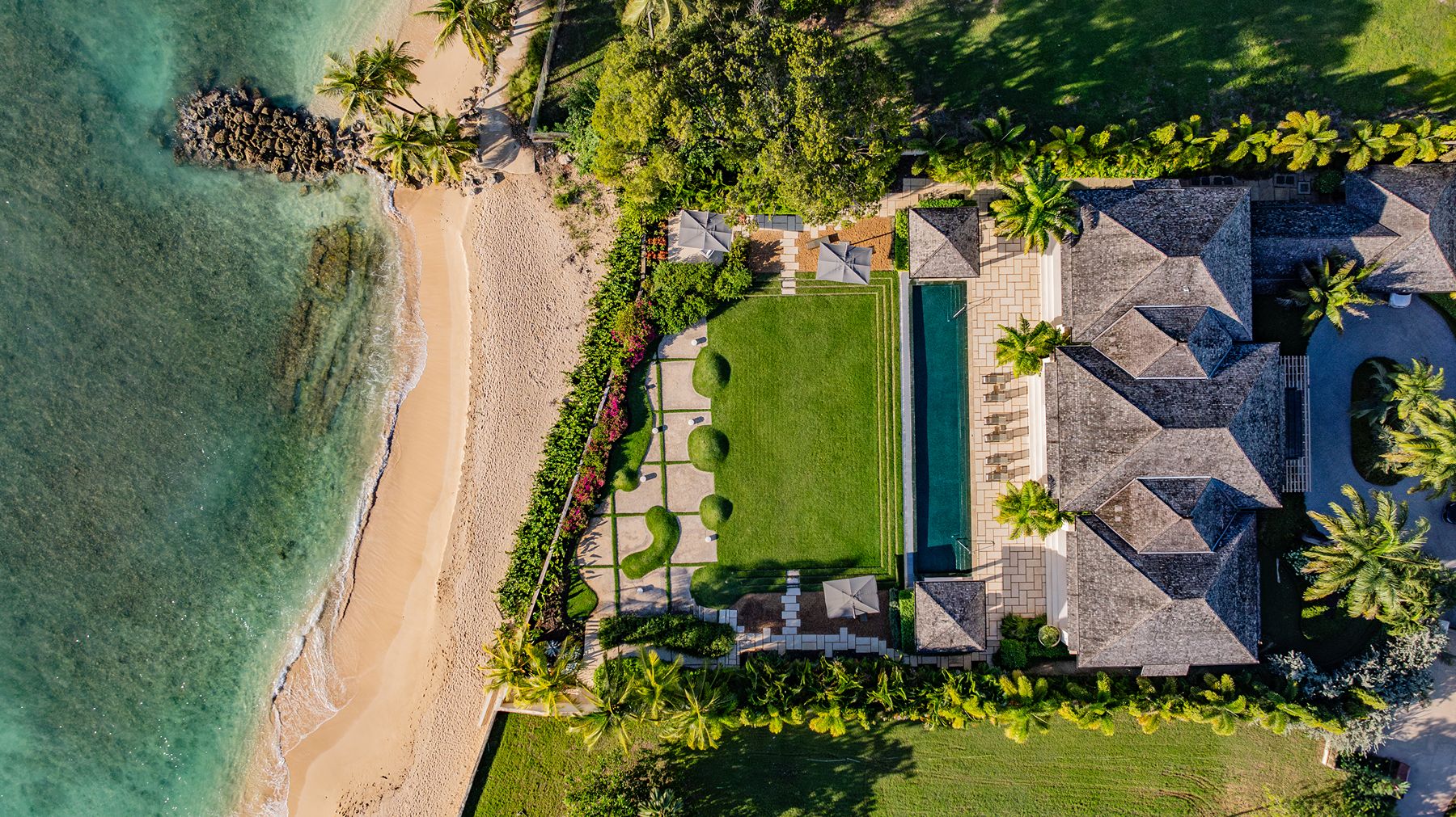 Aerial shot of villa with its garden and the beach at Godings Beach House in Barbados