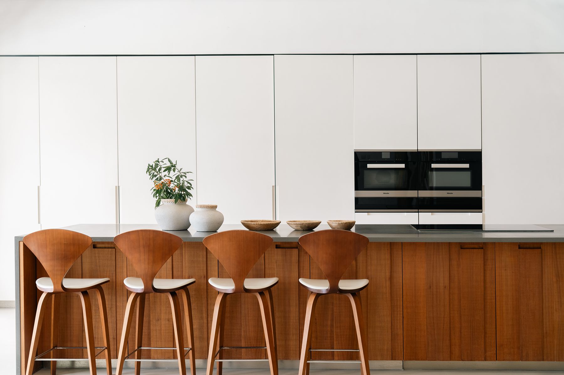 Kitchen with island and dining chairs at Godings Beach House in Barbados