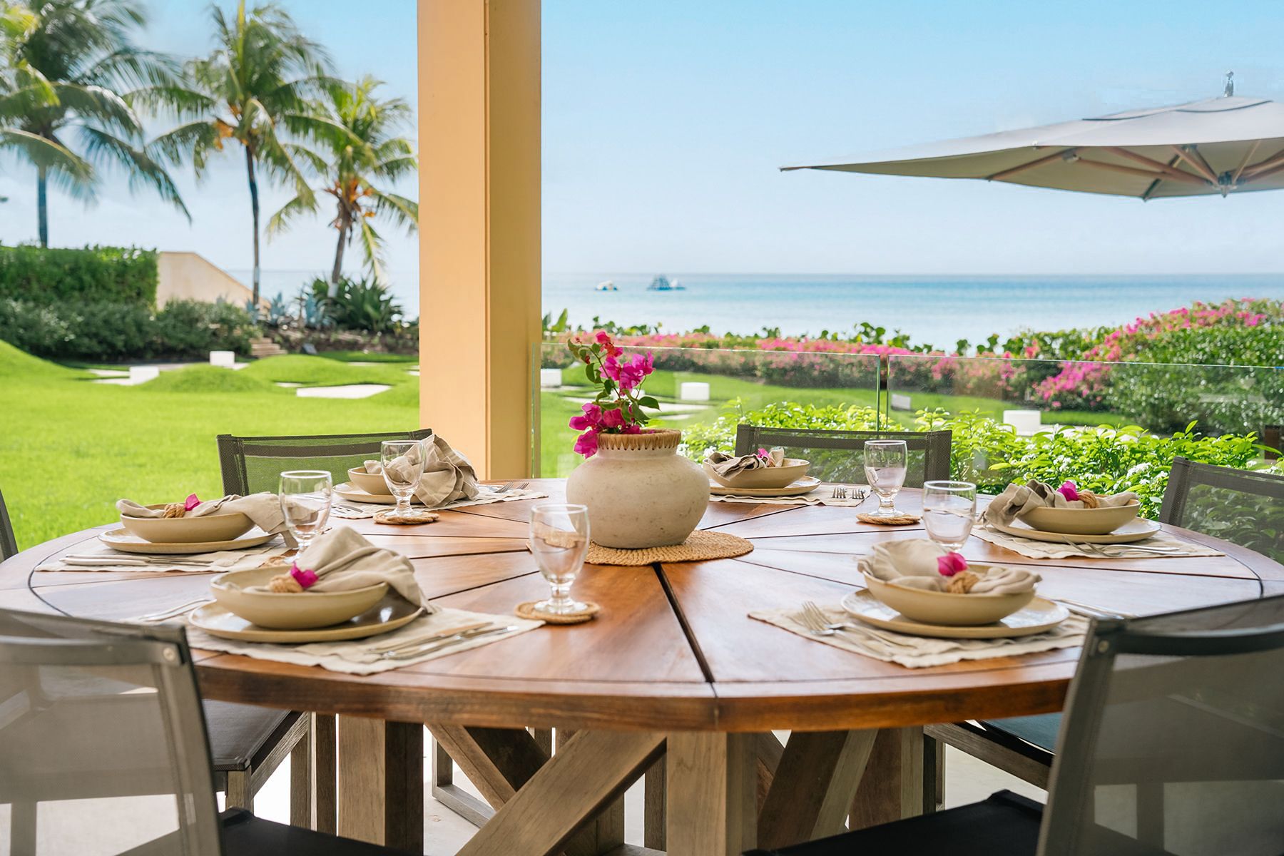 Outdoor dining table with view of the sea at Godings Beach House in Barbados