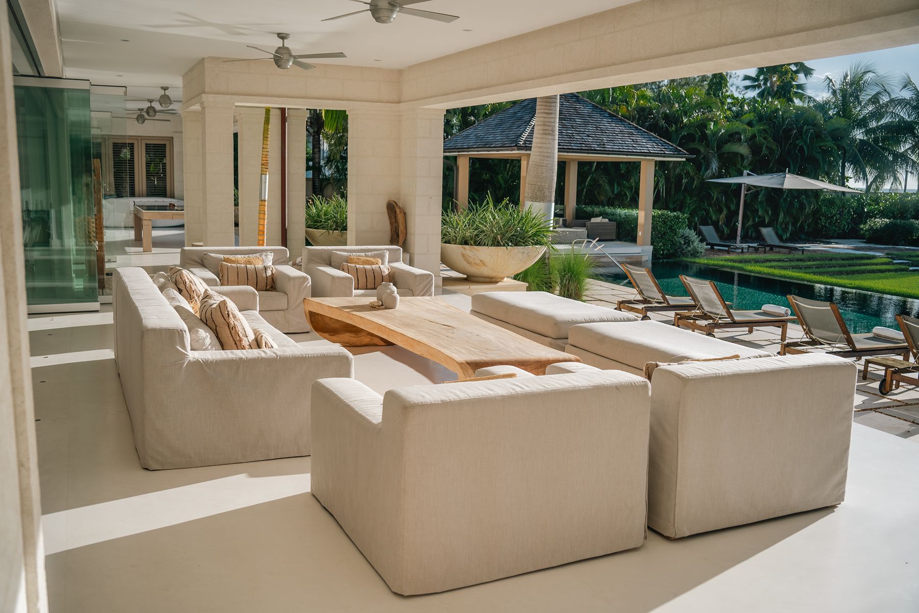 Outdoor seating by the pool at Godings Beach House in Barbados