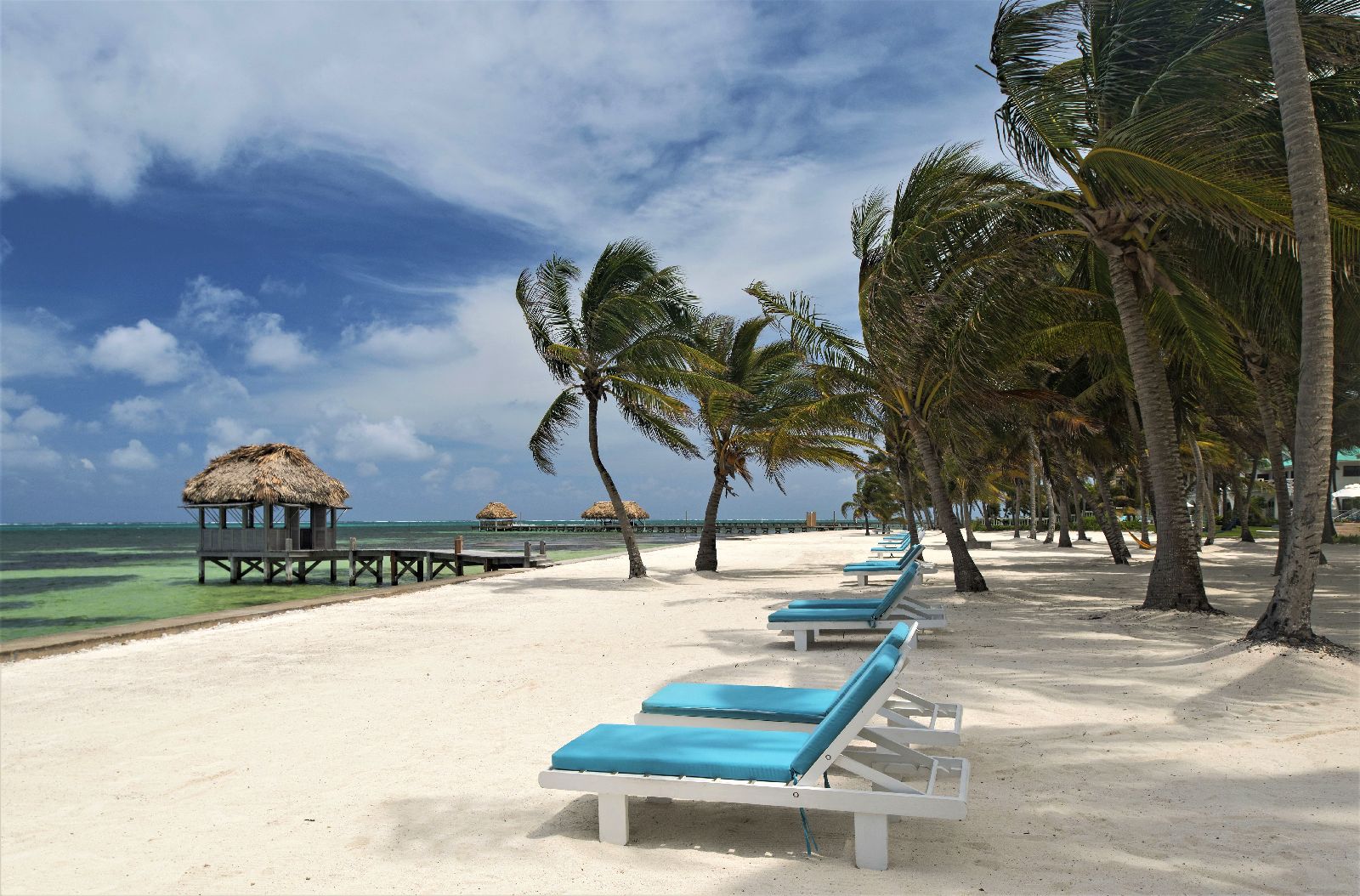 Loungers on the beach at Victoria House resort on Ambergris Caye Belize