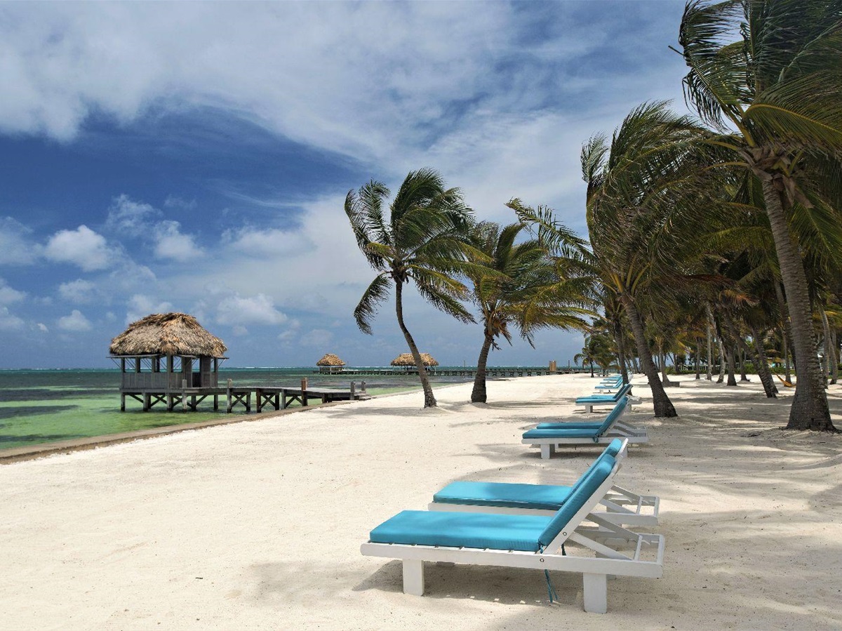 Loungers on the beach at Victoria House resort on Ambergris Caye Belize