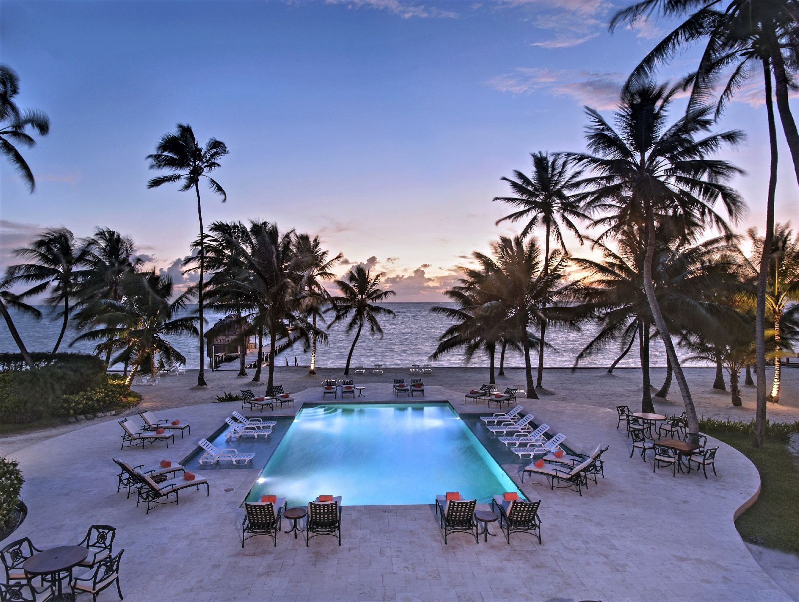 Sunset over the pool and beach at Victoria House resort on Ambergris Caye Belize