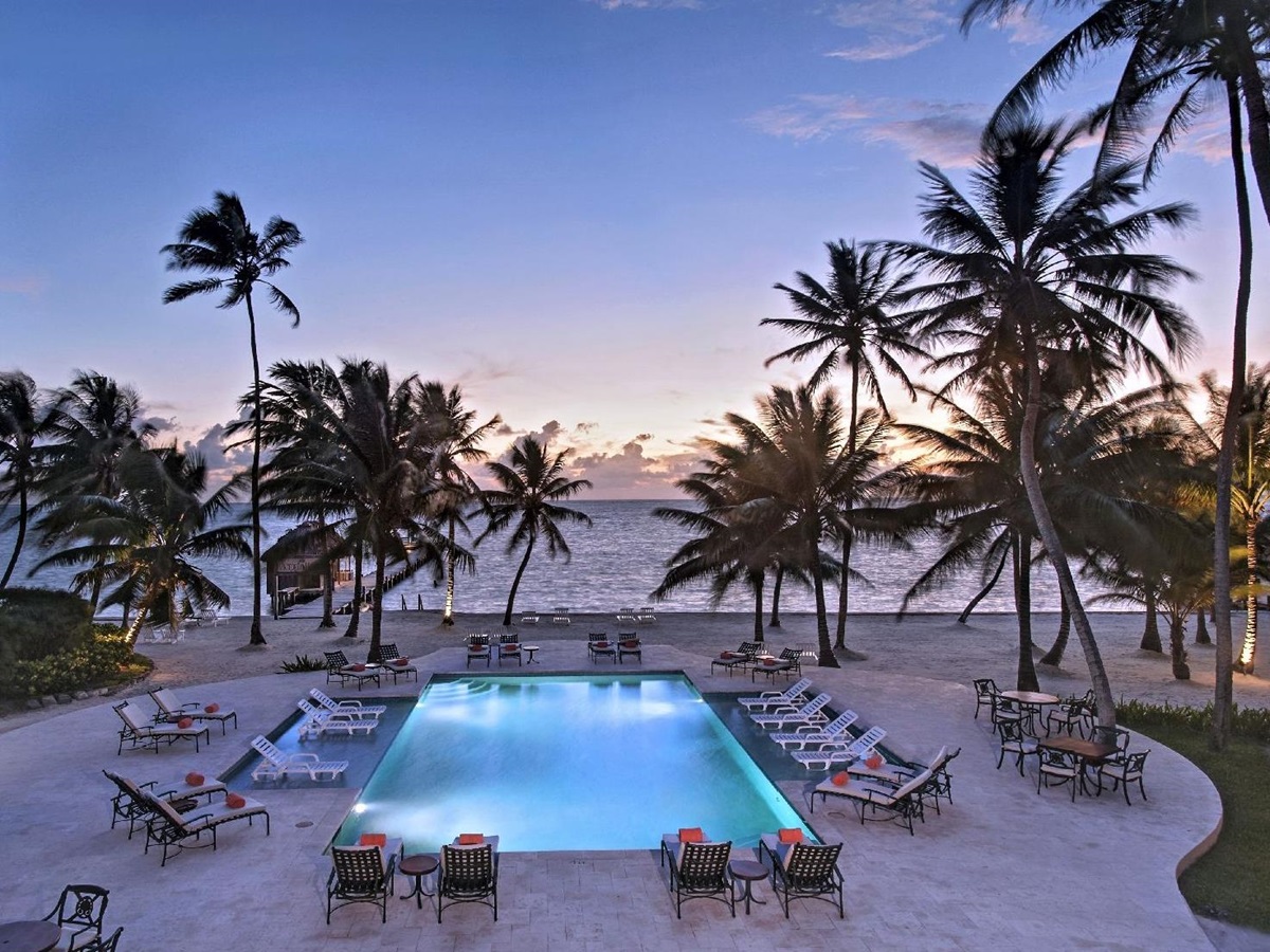 Sunset over the pool and beach at Victoria House resort on Ambergris Caye Belize