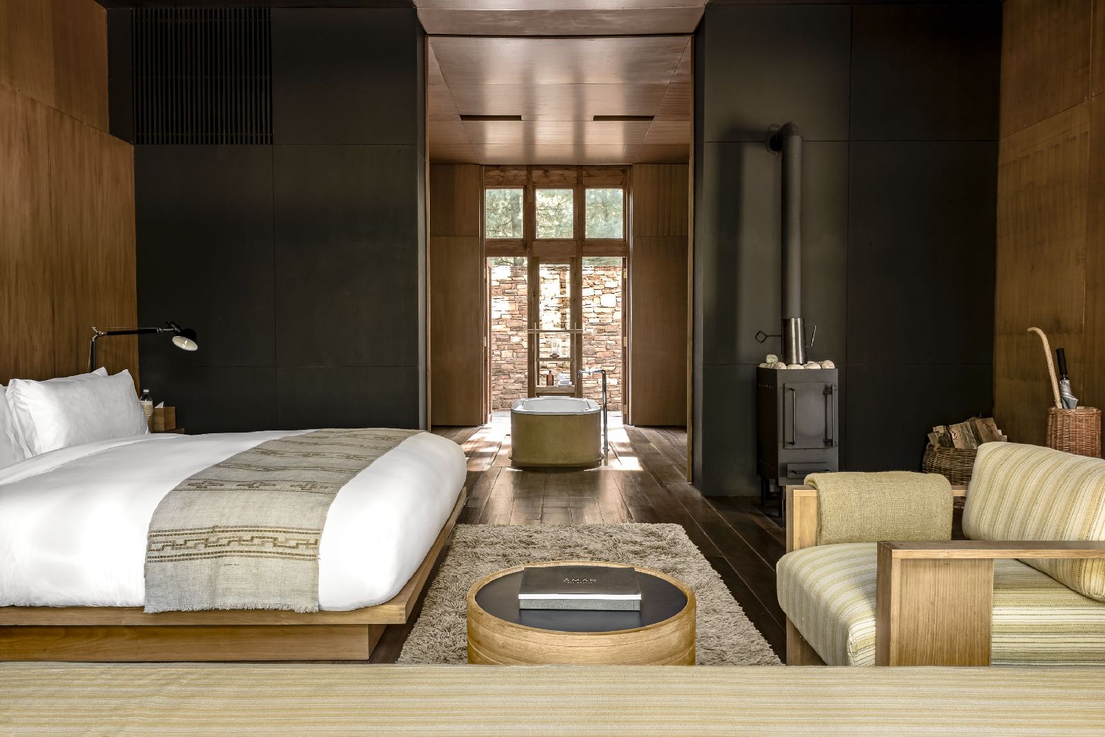 Sleek and bright suite boasts natural woods and materials with indoor fireplace at luxury hotel Amankora Paro in Bhutan