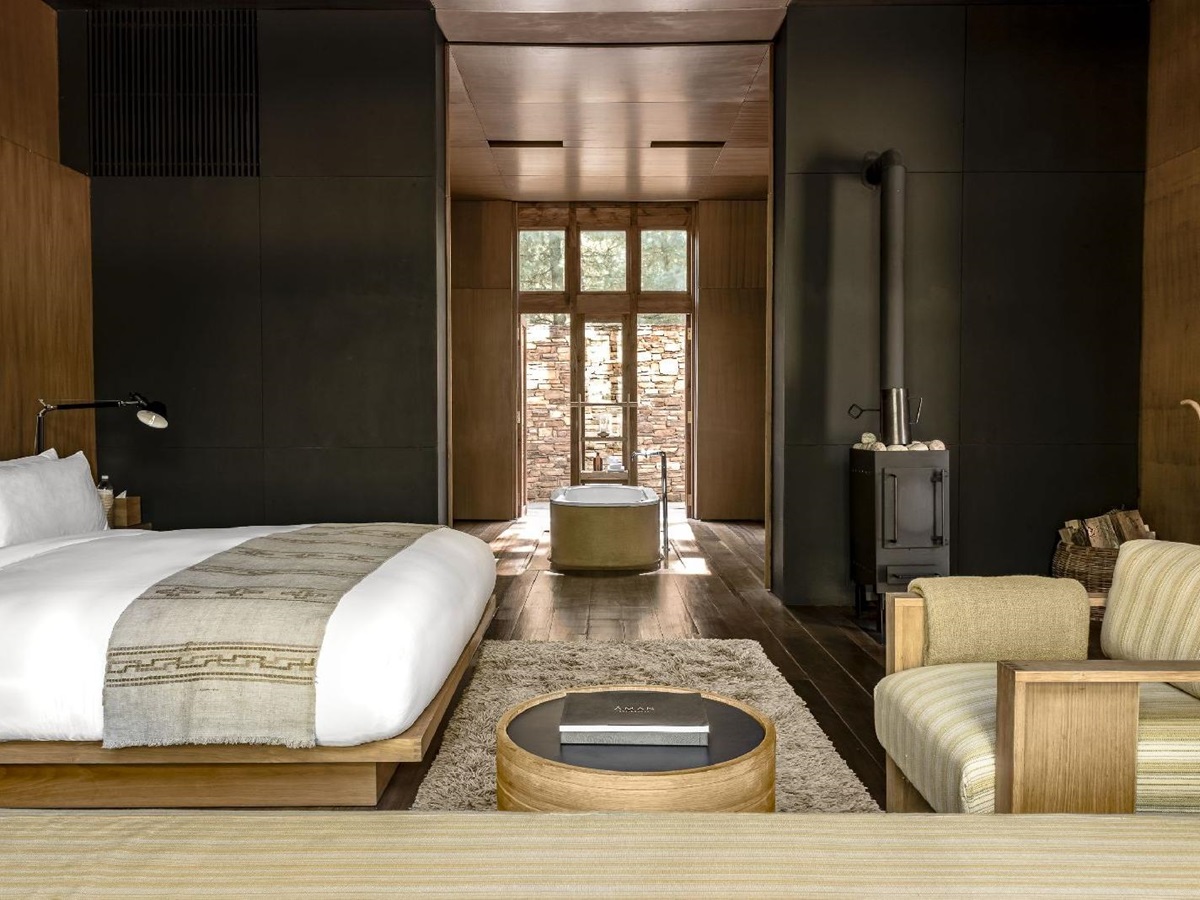 Sleek and bright suite boasts natural woods and materials with indoor fireplace at luxury hotel Amankora Paro in Bhutan