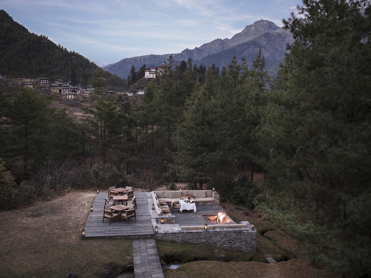 Hidden and secluded outdoor fireplace and terrace among forest trees at luxury hotel Amankora Paro in Bhutan