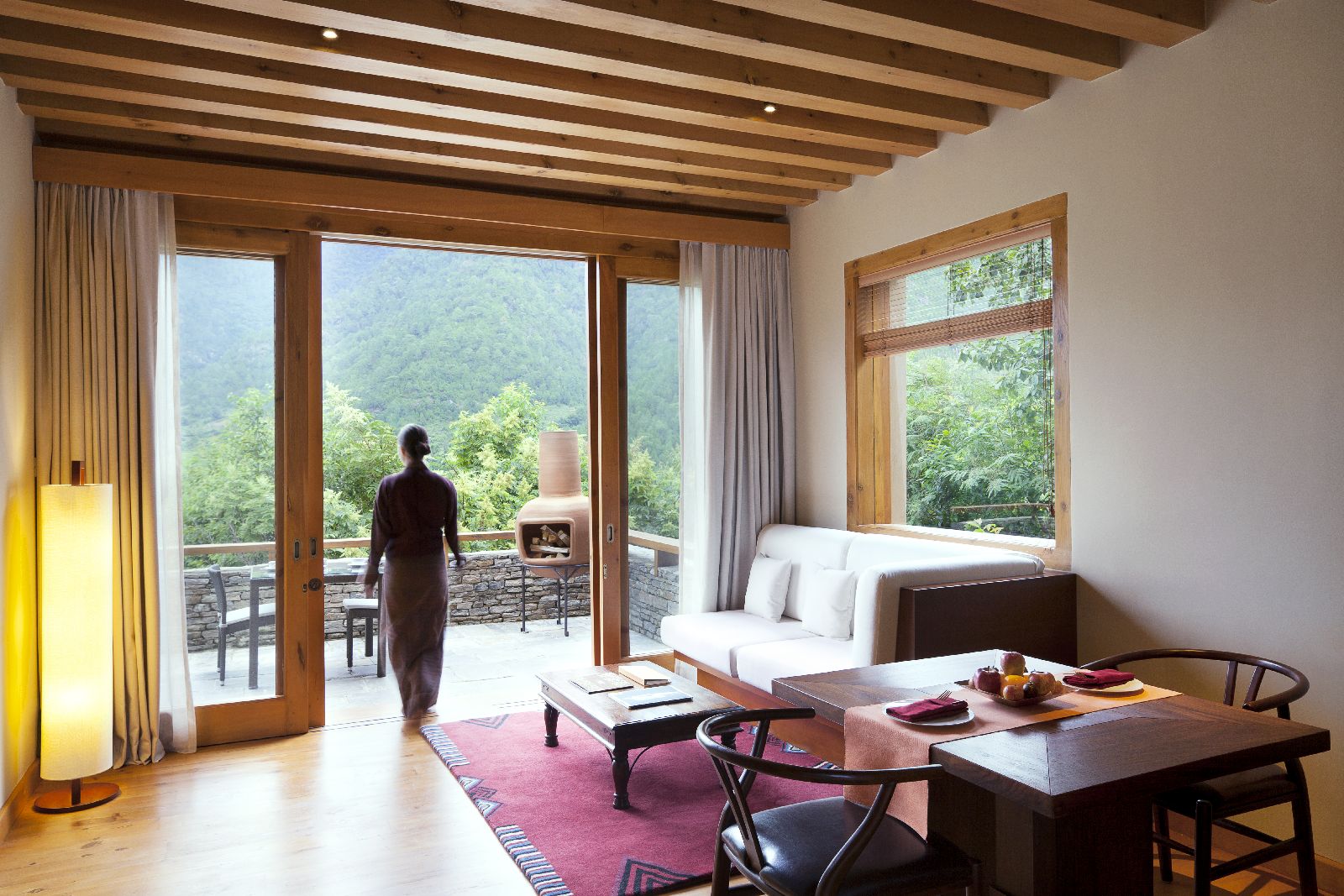 Living area and private terrace of a villa at COMO Uma Punakha in Bhutan