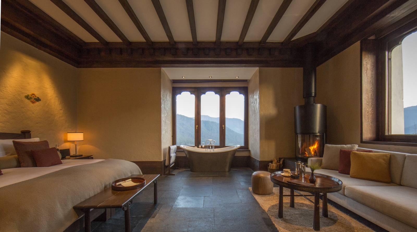 Main bedroom with beamed ceiling and roll top bath