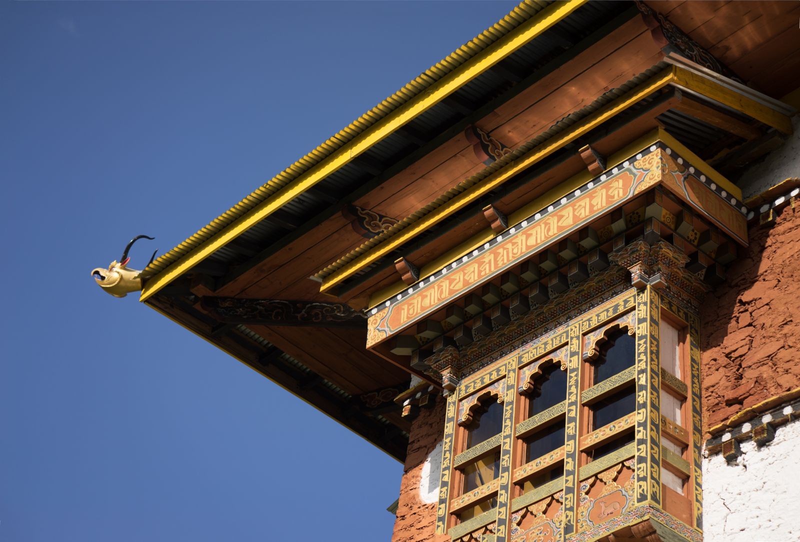 The edge of a historic roof with ornate carvings