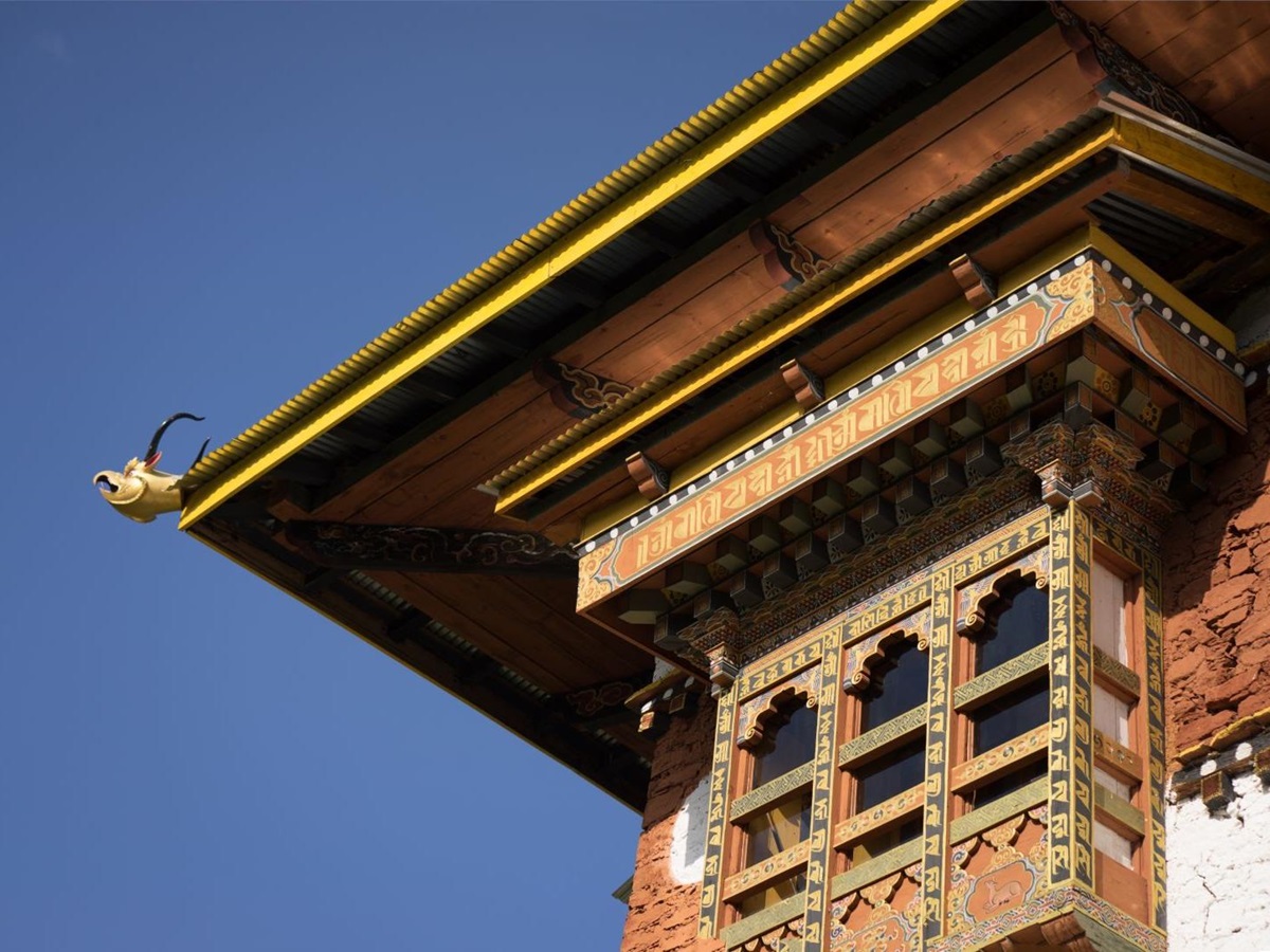 The edge of a historic roof with ornate carvings
