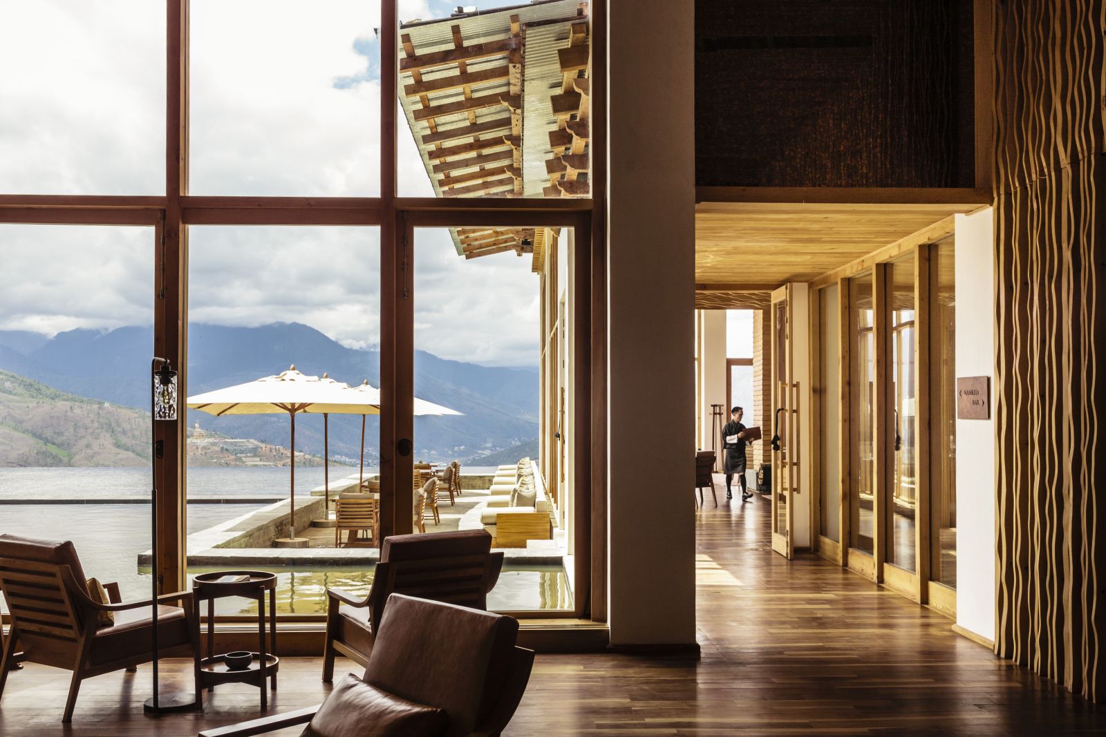 Main sunlit lobby with seating and mountain view at Six Senses Thimpu