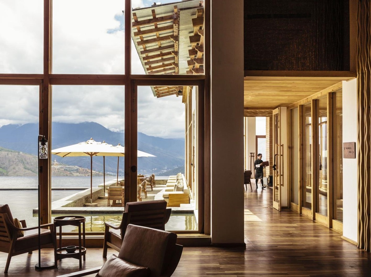 Main sunlit lobby with seating and mountain view at Six Senses Thimpu