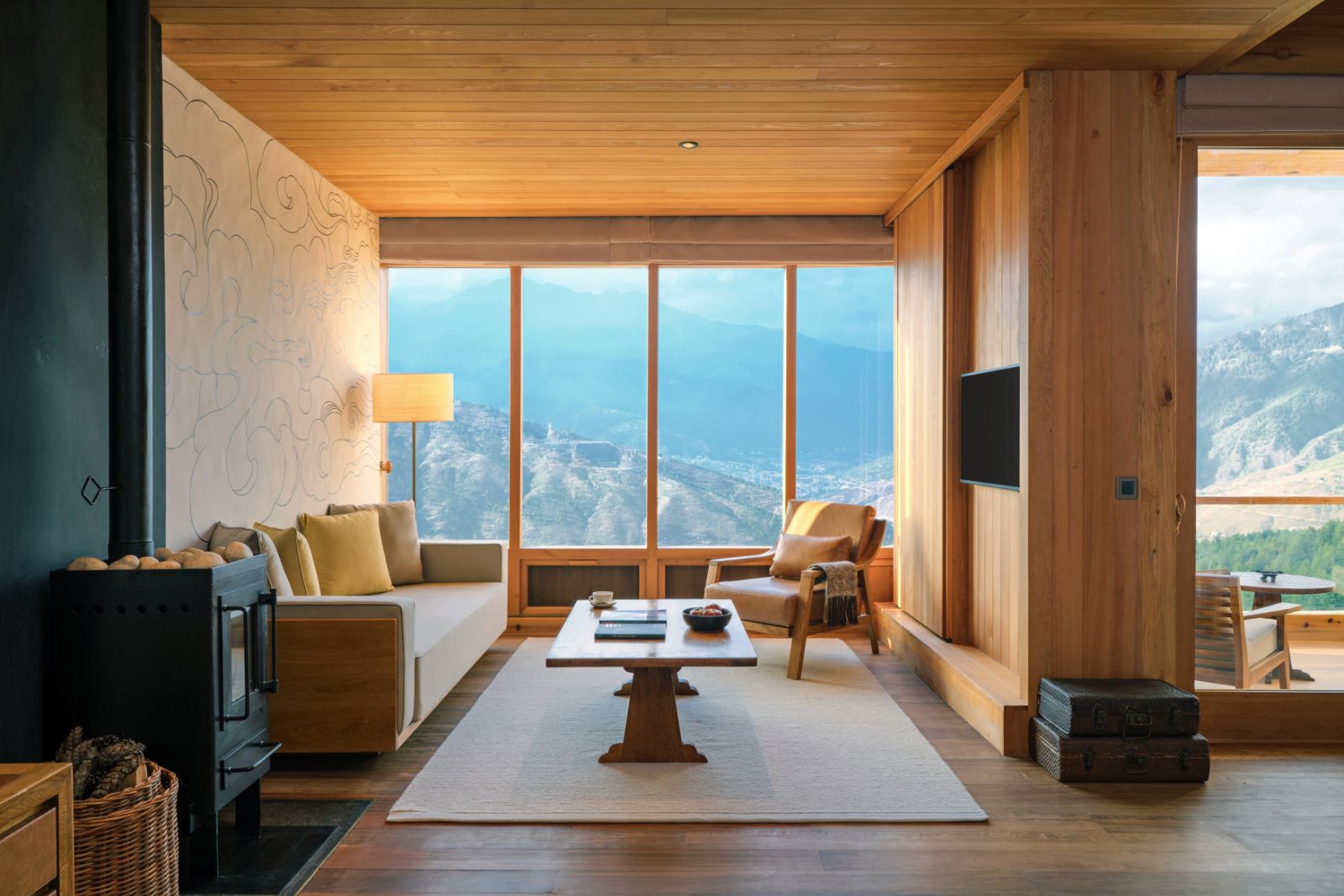 Floor-to-ceiling windows overlooking the mountains in the Thimpu Suite at luxury hotel Six Senses Thimpu Lodge in Bhutan