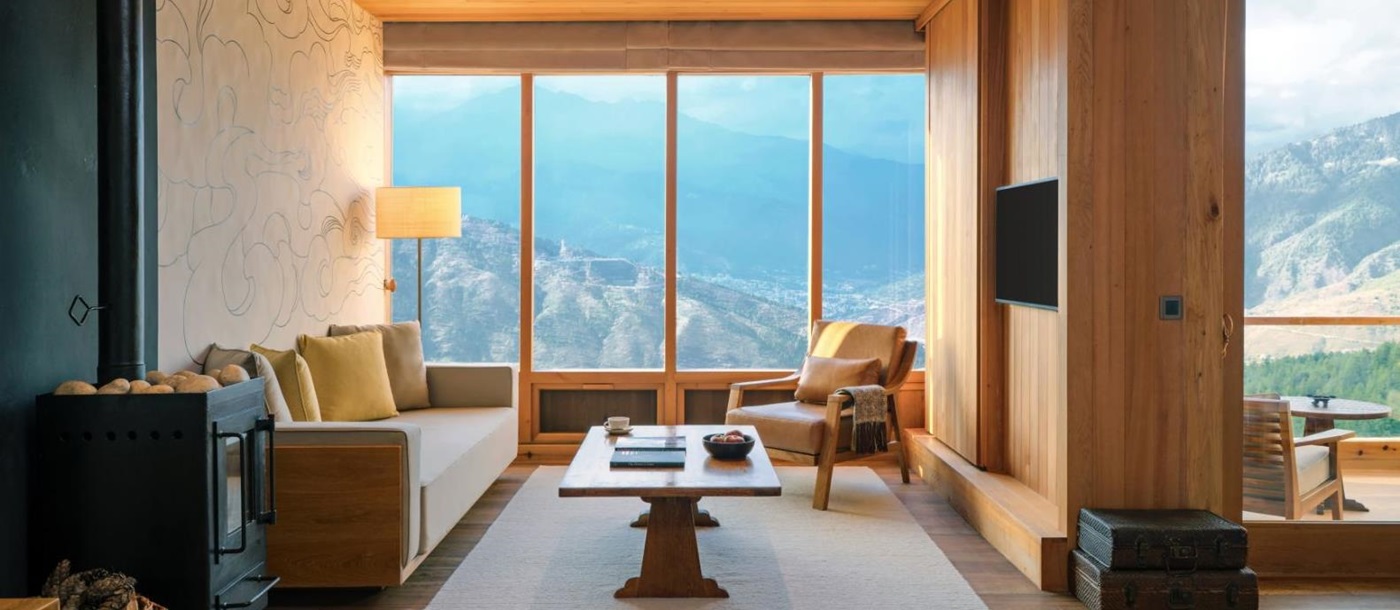 Floor-to-ceiling windows overlooking the mountains in the Thimpu Suite at luxury hotel Six Senses Thimpu Lodge in Bhutan