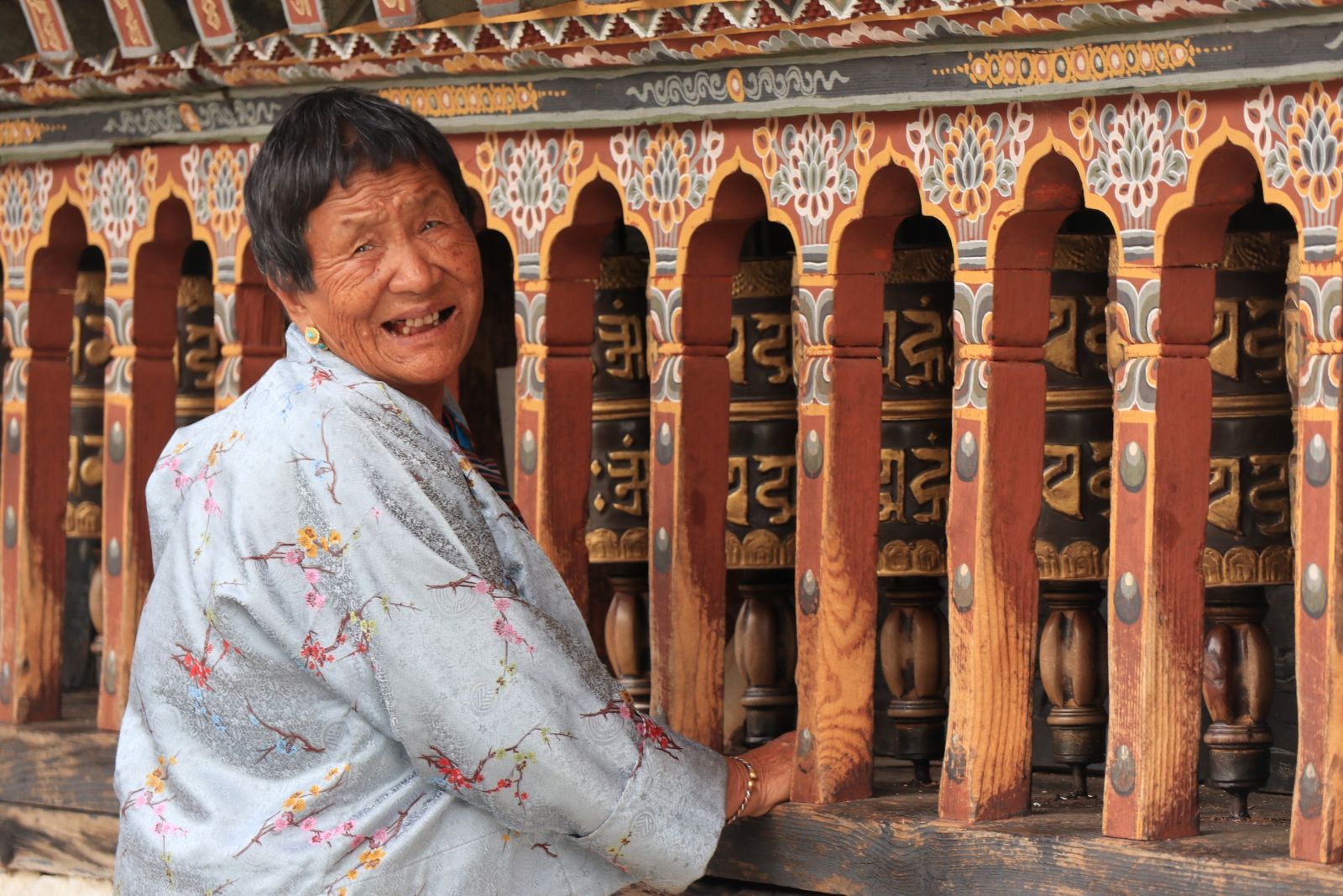 Lady making an offering at a temple in Bhutan