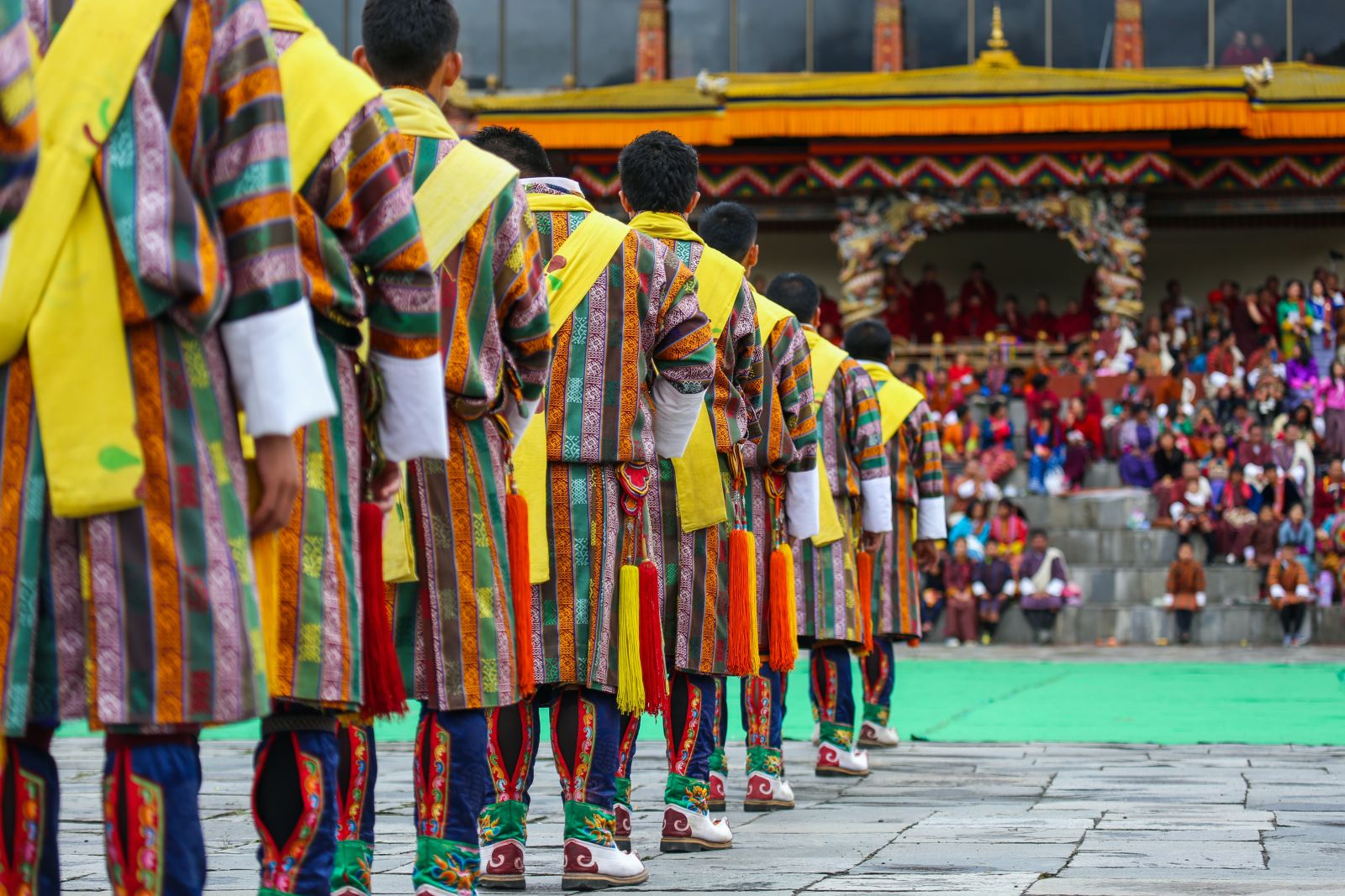 Men in traitional dress at a colourful ceremony in Thimphu Bhutan