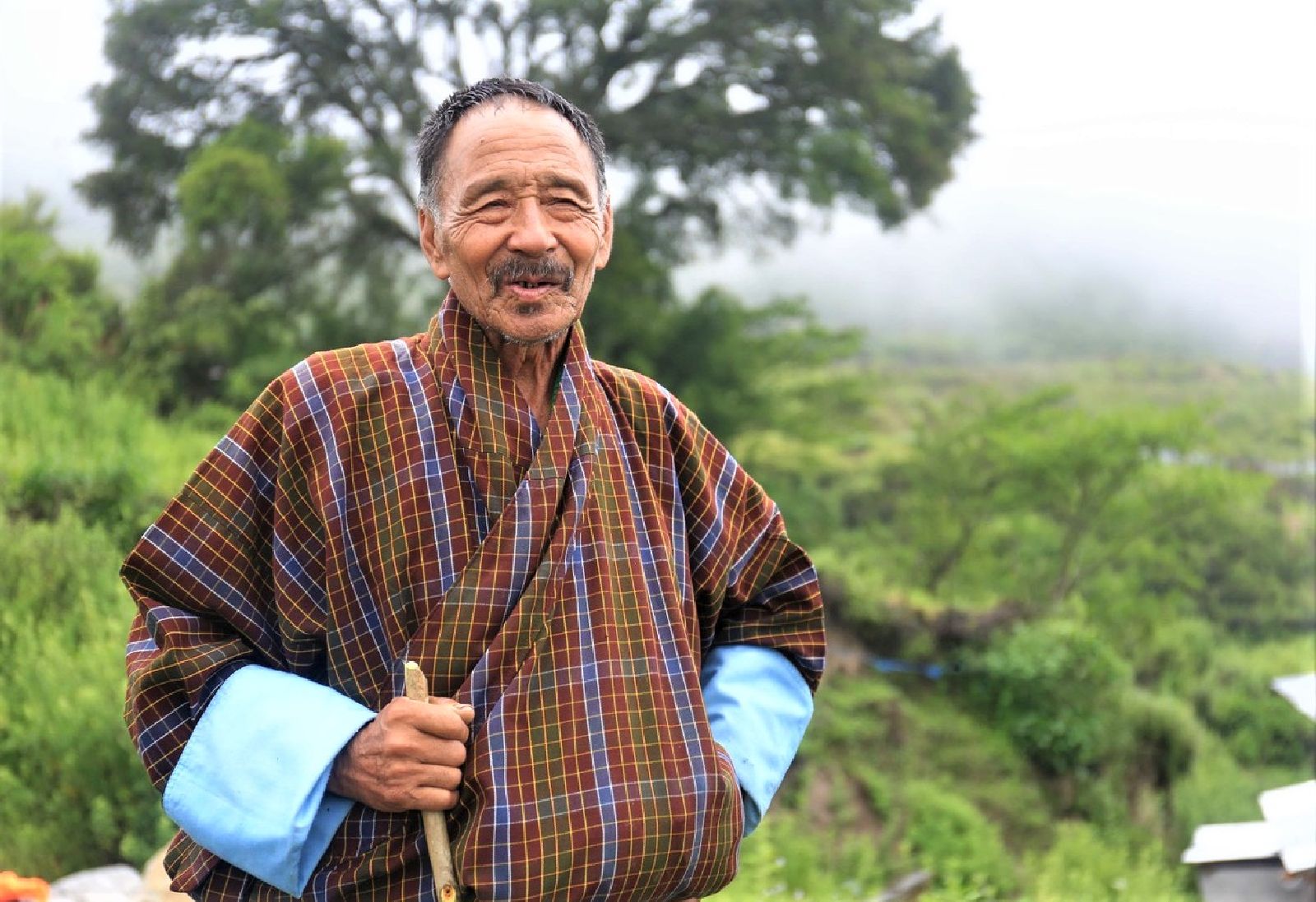 Smiling Bhutanese man in community on the Trans-Bhutan Trail