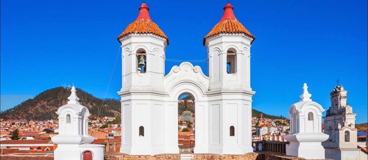 Whitewashed towers set against a bright blue sky in the city of Sucre in Bolivia