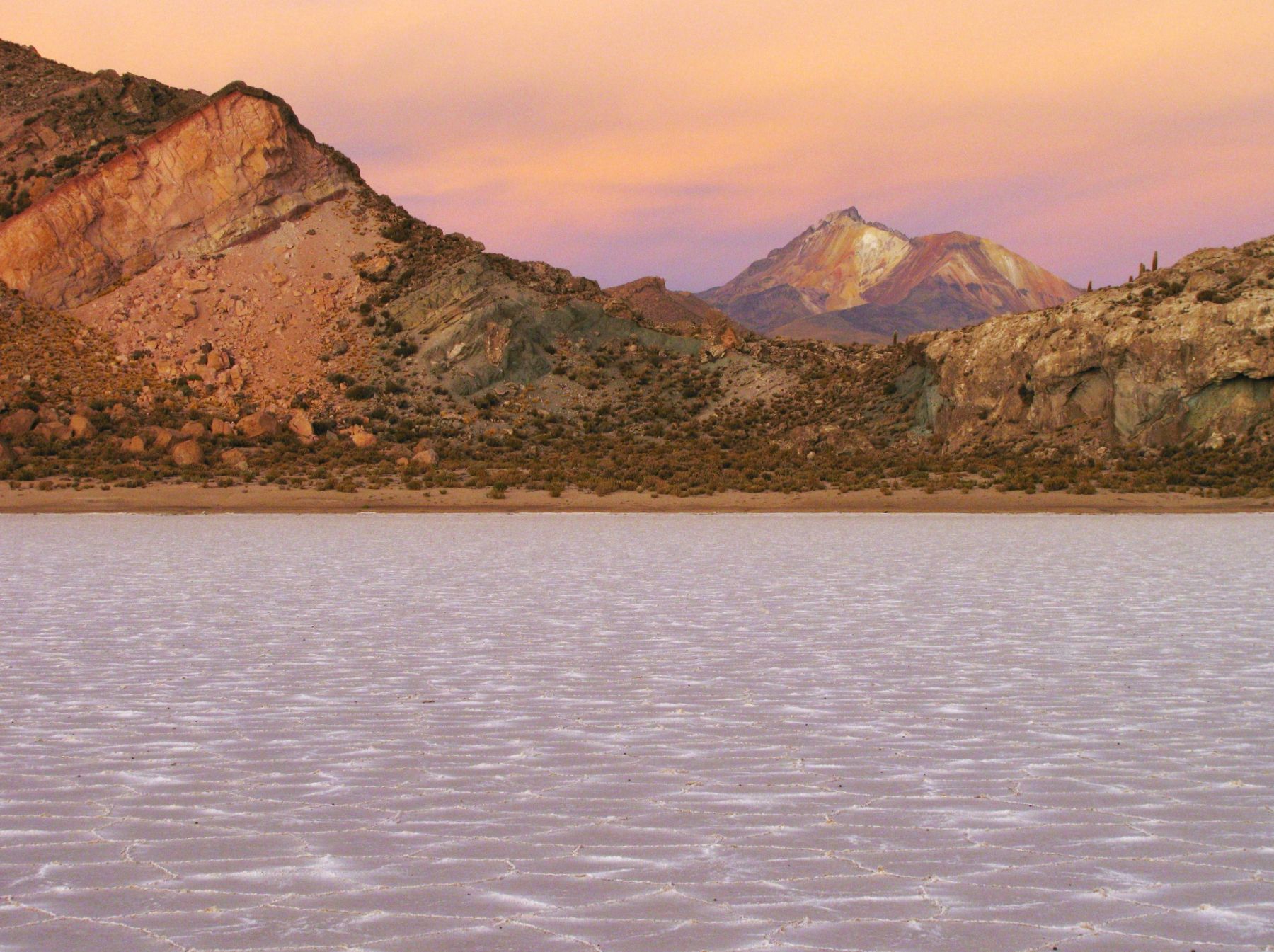 The Uyuni salt flat in Bolivia at dusk with the Tunupa volcano in the distance