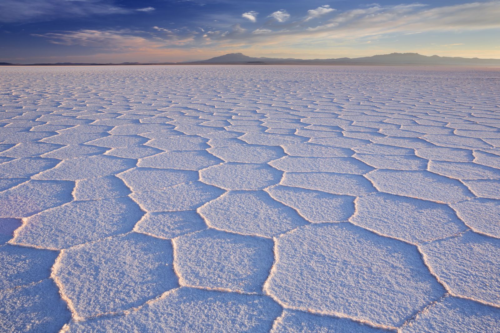A wide expanse of sections of white salt in the Uyuni salt flats in Bolivia