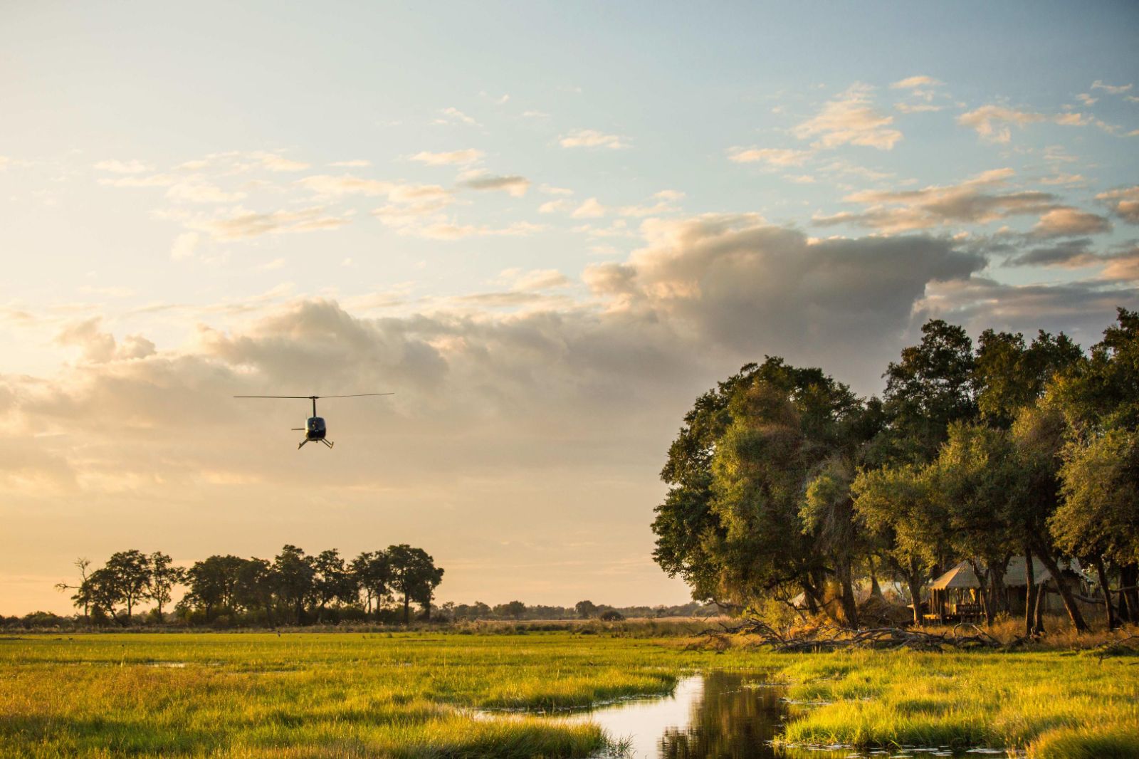 Helicopter arrival at Duba Explorers Camp on the Okavango Delta in Botswana