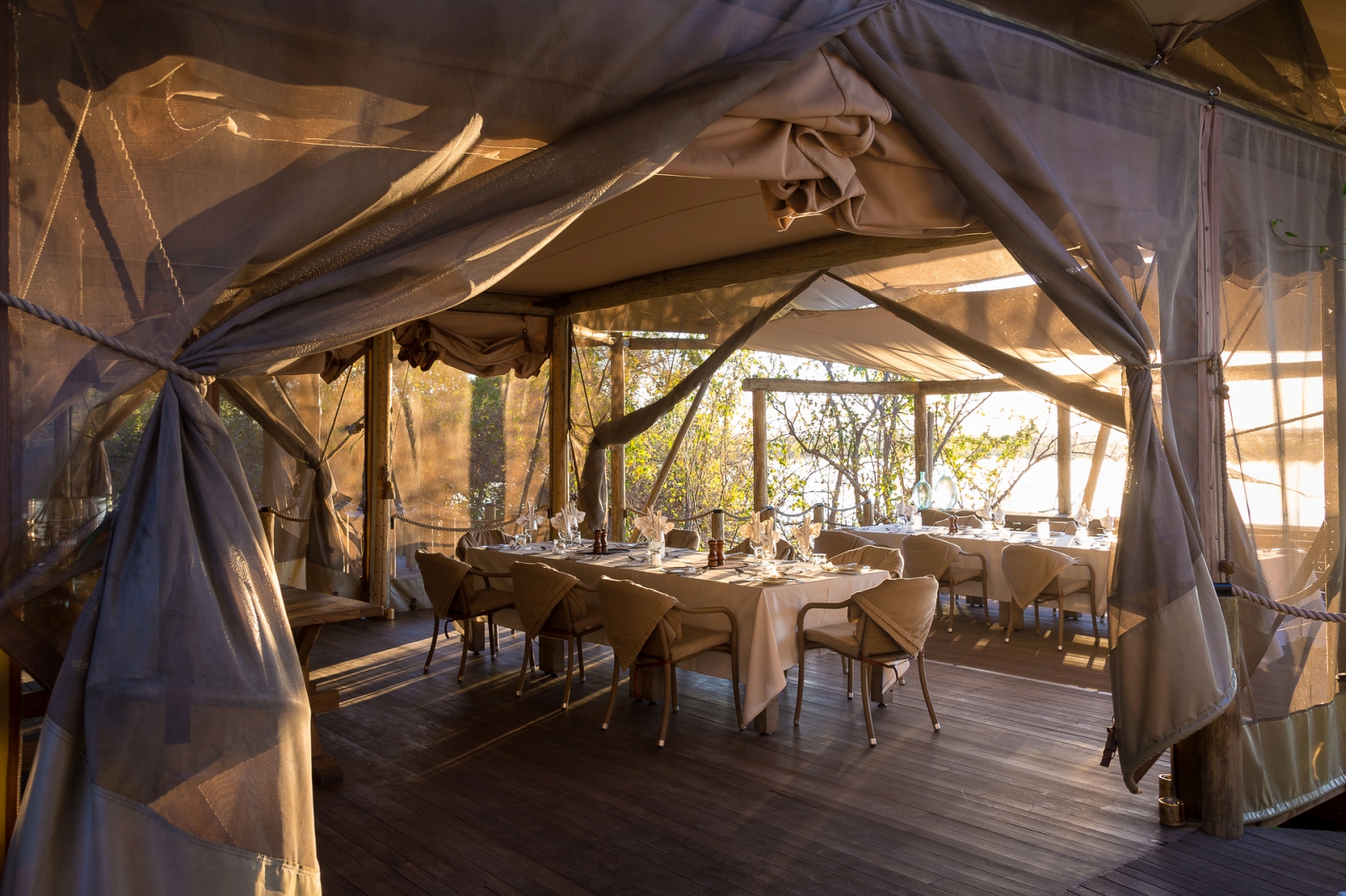 Dining area at DumaTau in Botswana -set up for dinner with view over the Okavango Delta