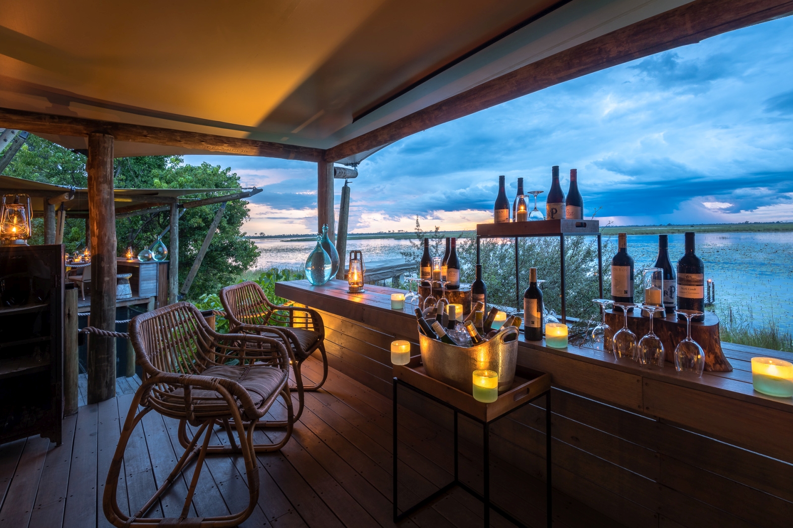 Two chairs with a selection of drinks overlooking Botswana's Okavango Delta at DumaTau