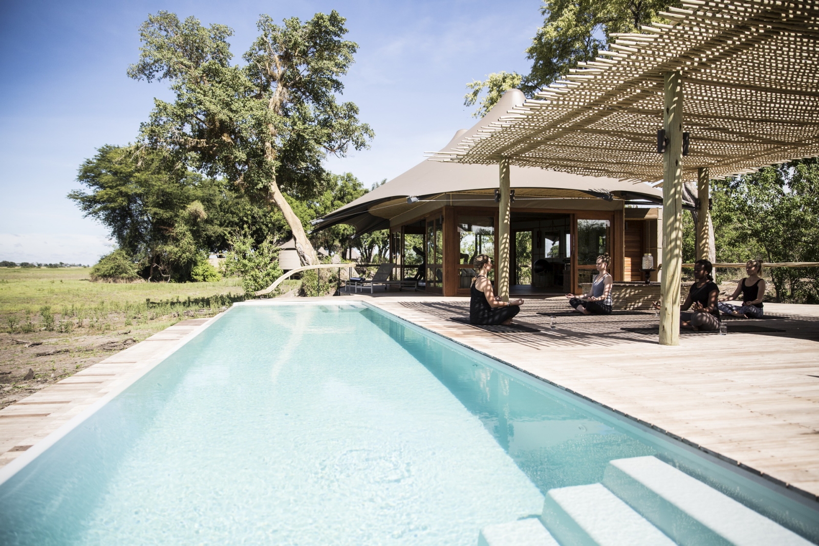 Poolside yoga session at Mombo camp