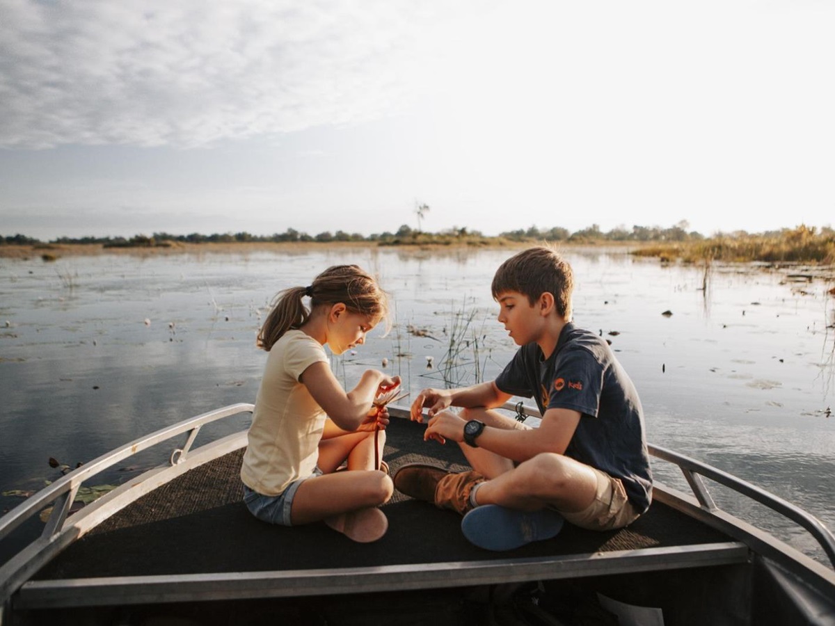 A family on a river safari from Vumbura Plains in Botswana's Okavango Delta