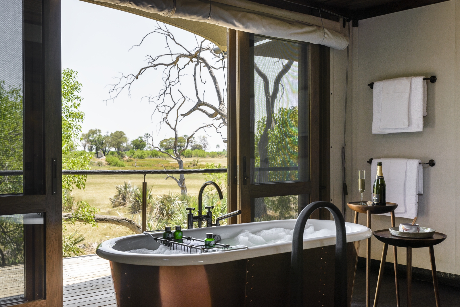 Freestanding bathtub in a luxury tent at luxury safari camp Xigera in the Okavango Delta, Botswana